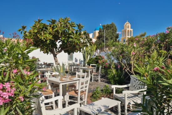 a white tables and chairs in a garden