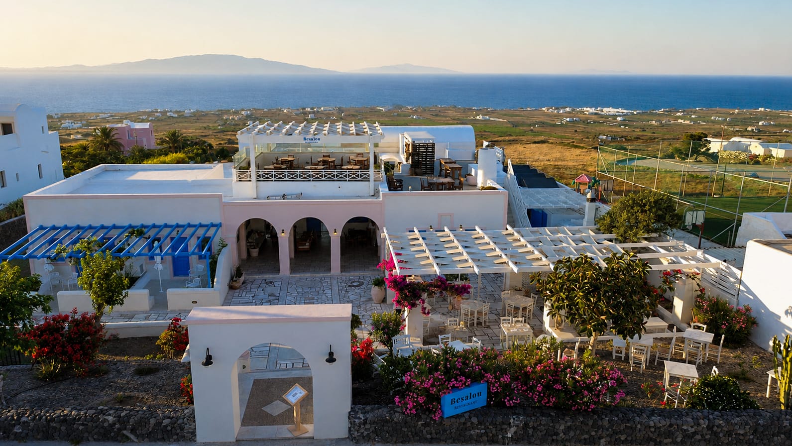 a white building with a large body of water in the background
