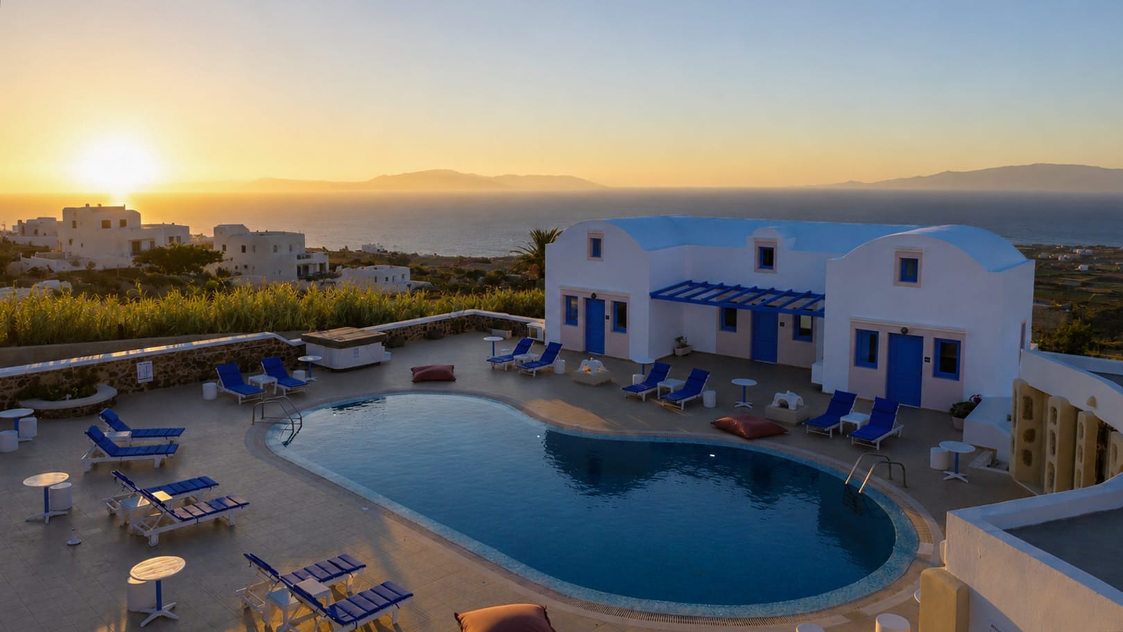 a pool with chairs and a building in the background