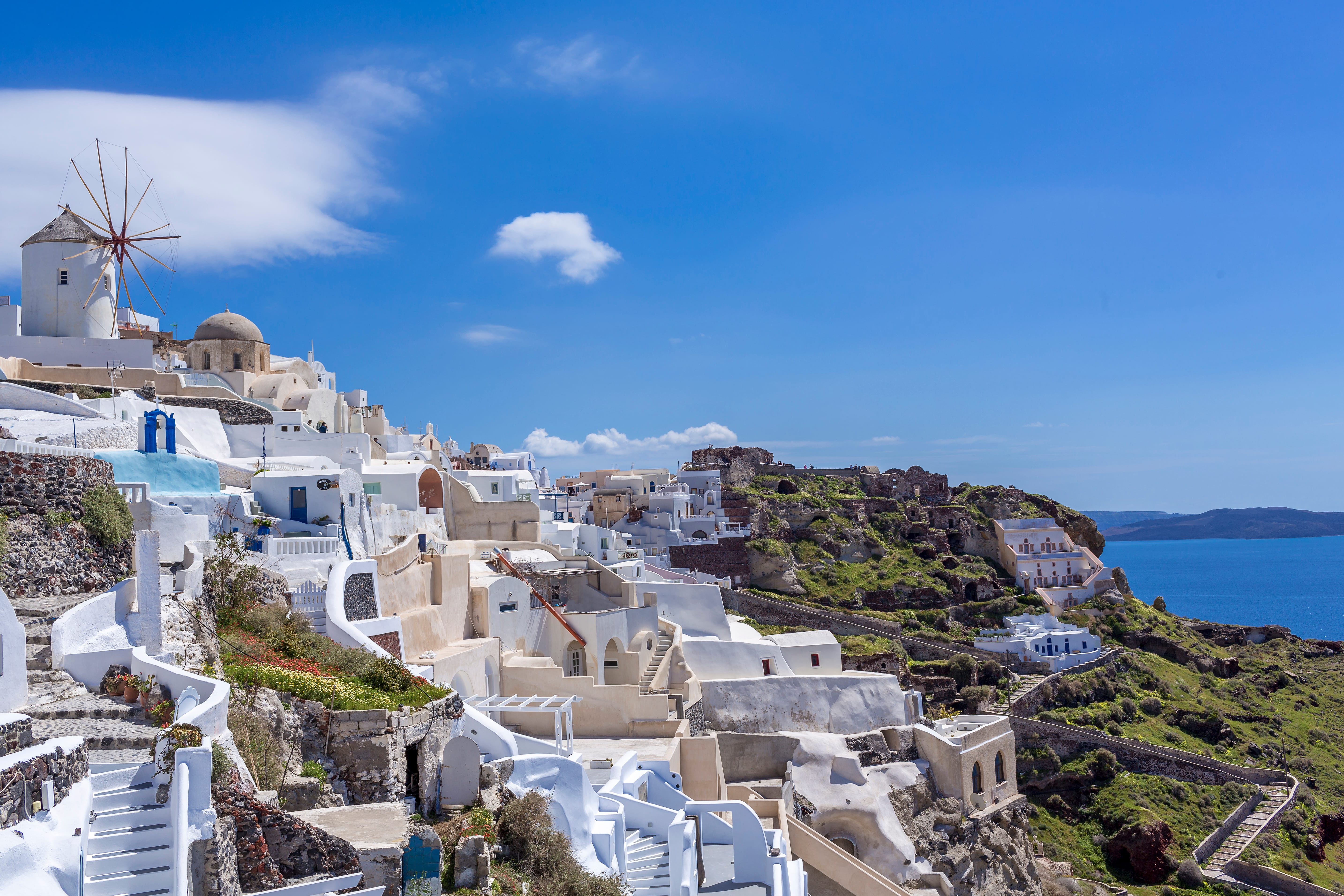 a white buildings on a cliff