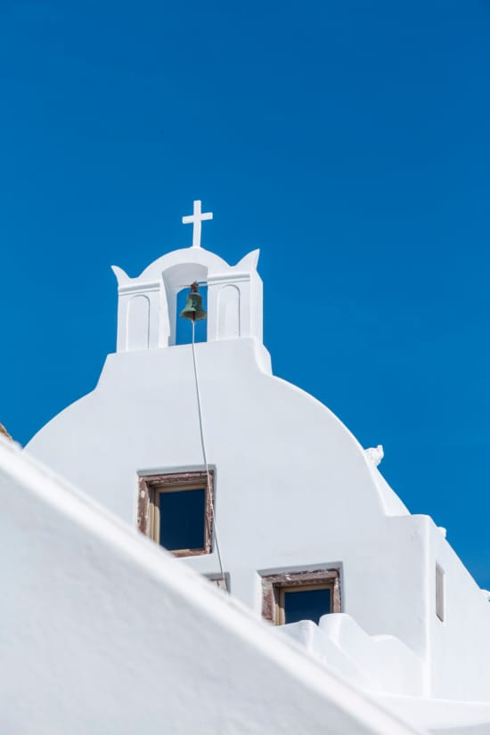 a white building with a bell on top