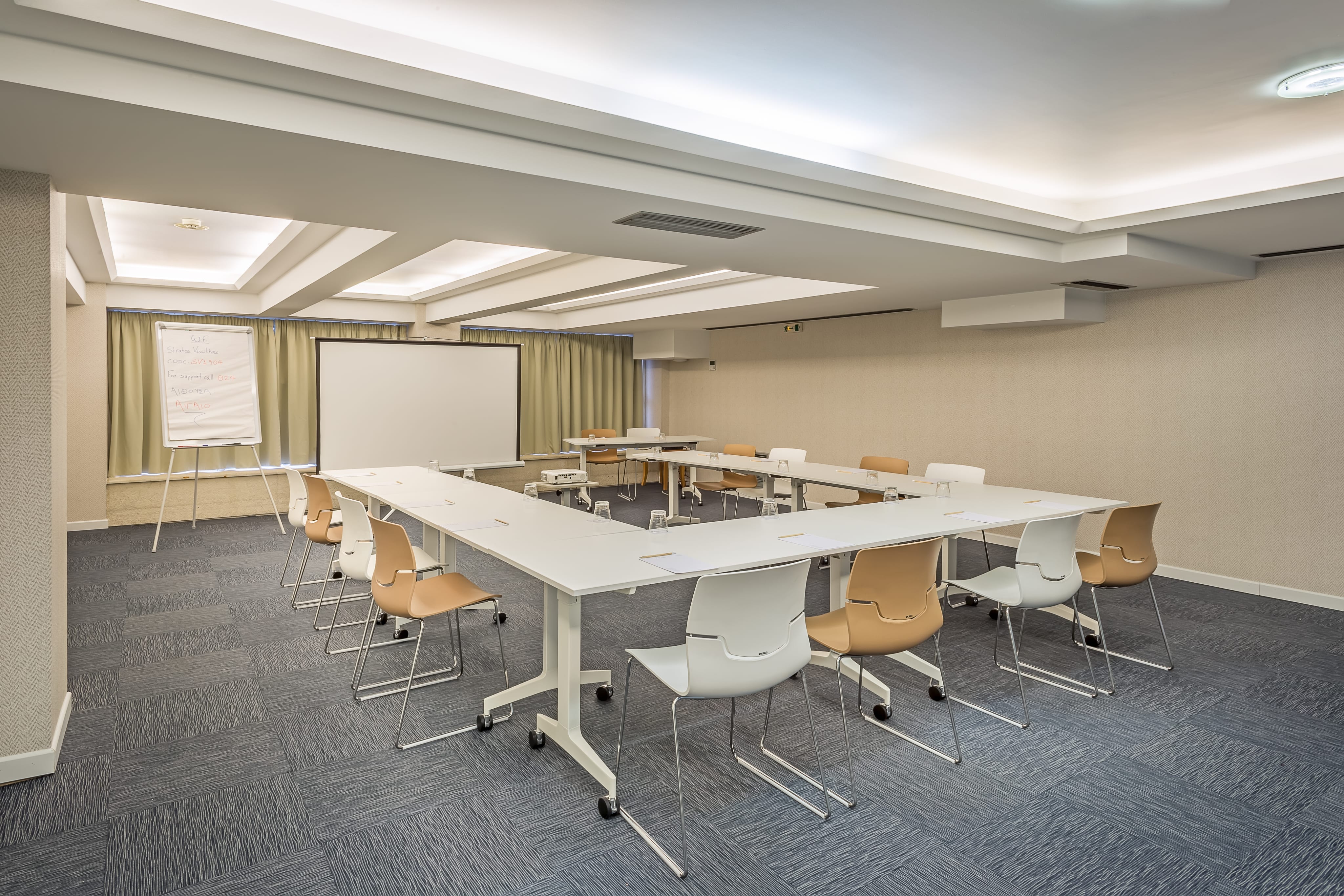 a room with a white board and tables