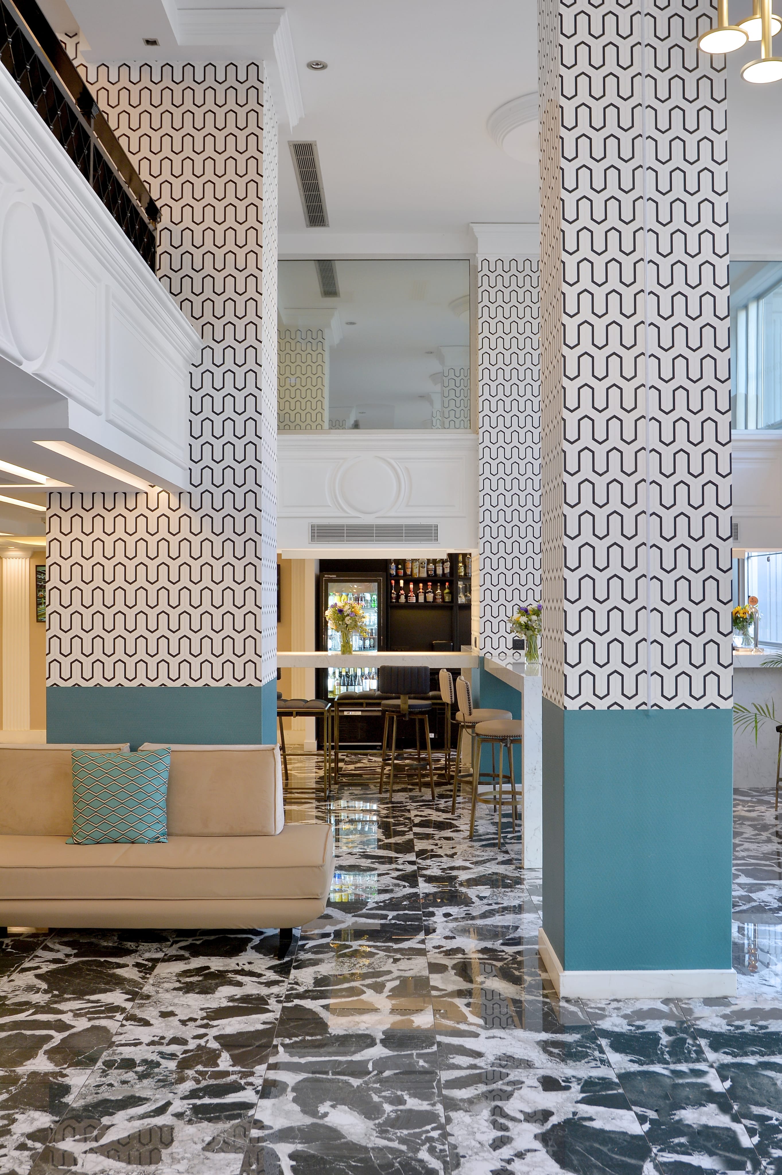 a room with a couch and a marble floor