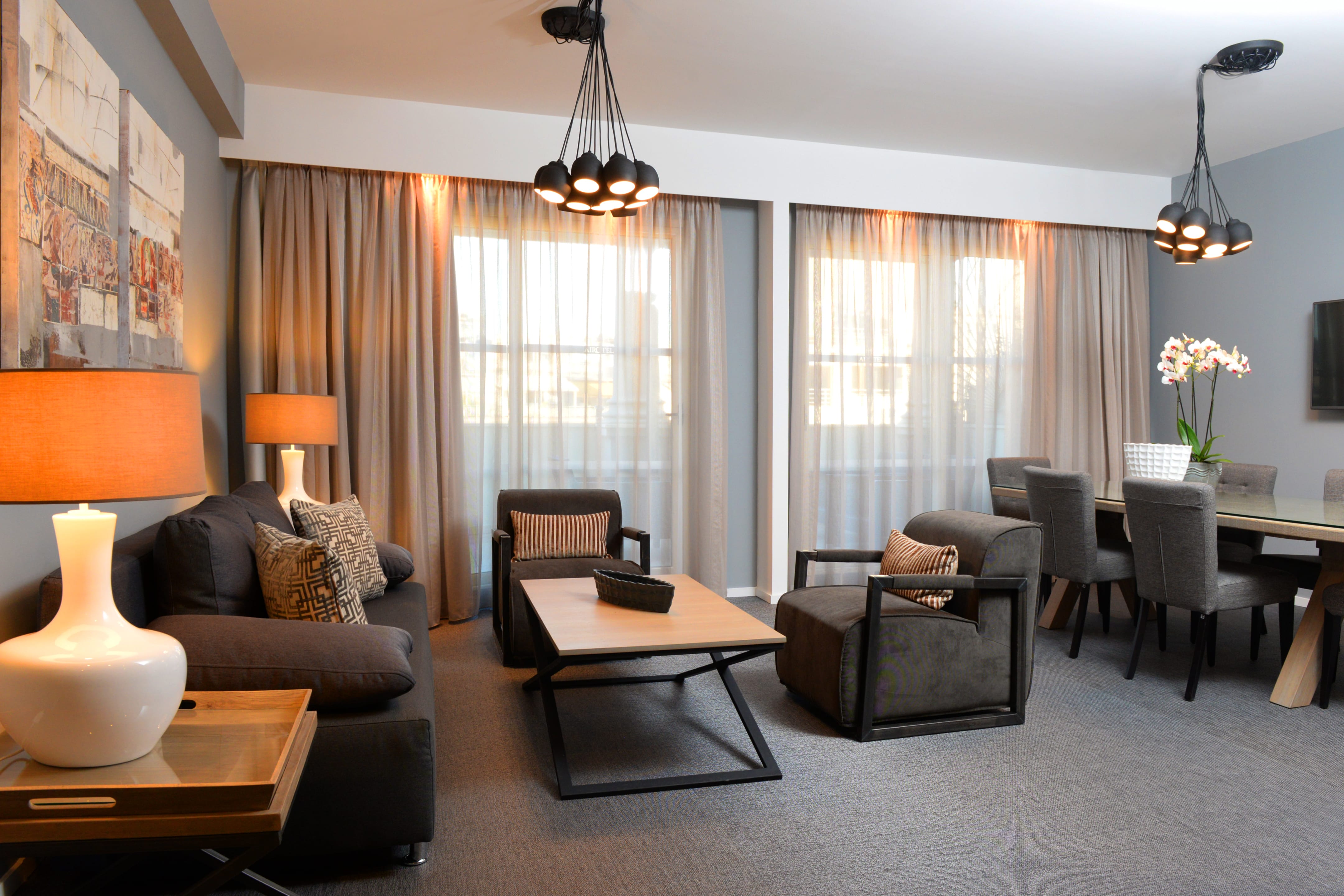a living room with couches and chairs