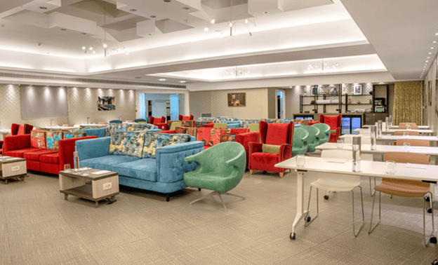 a room with colorful couches and tables