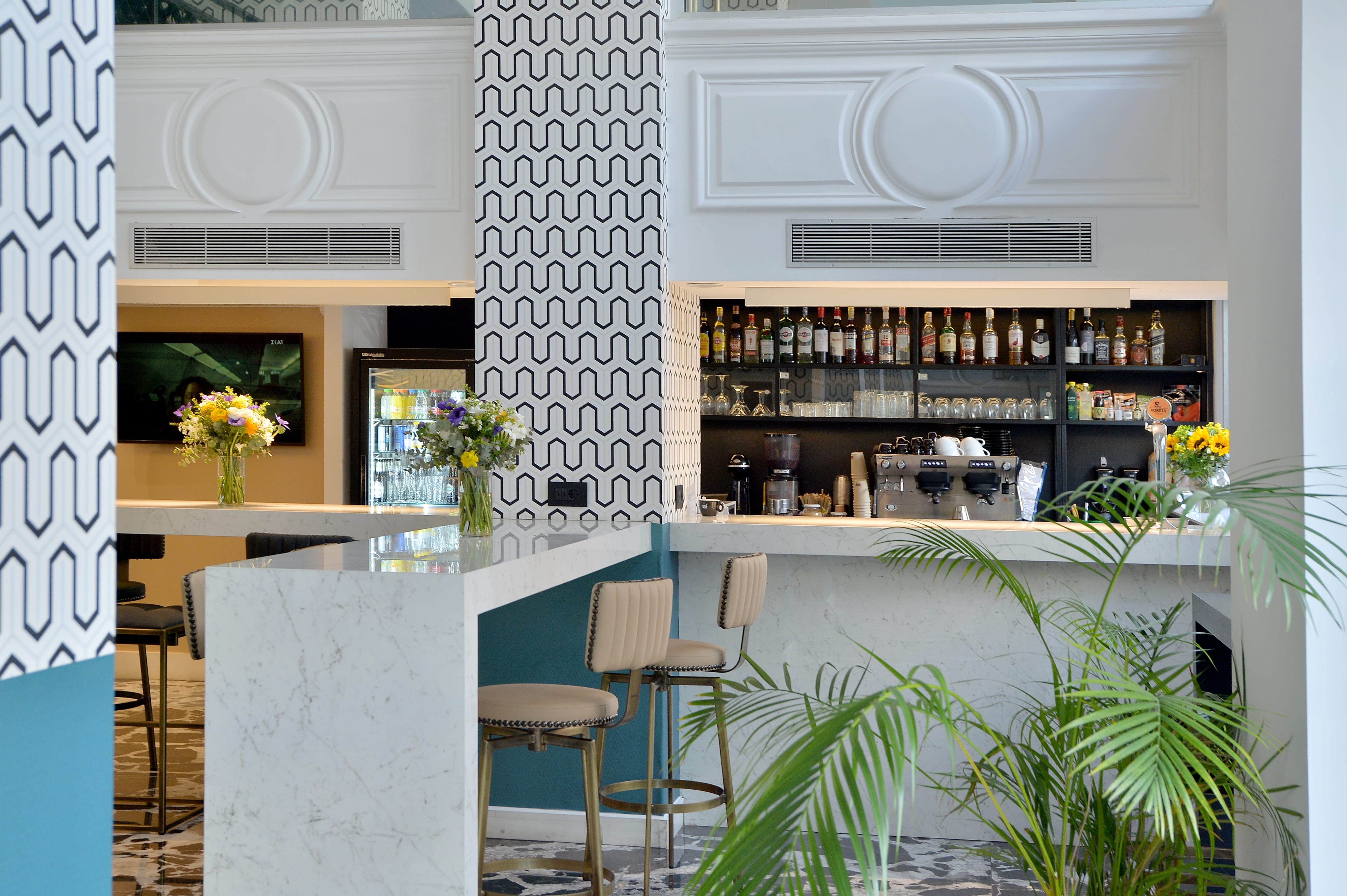 a bar with plants in front of it