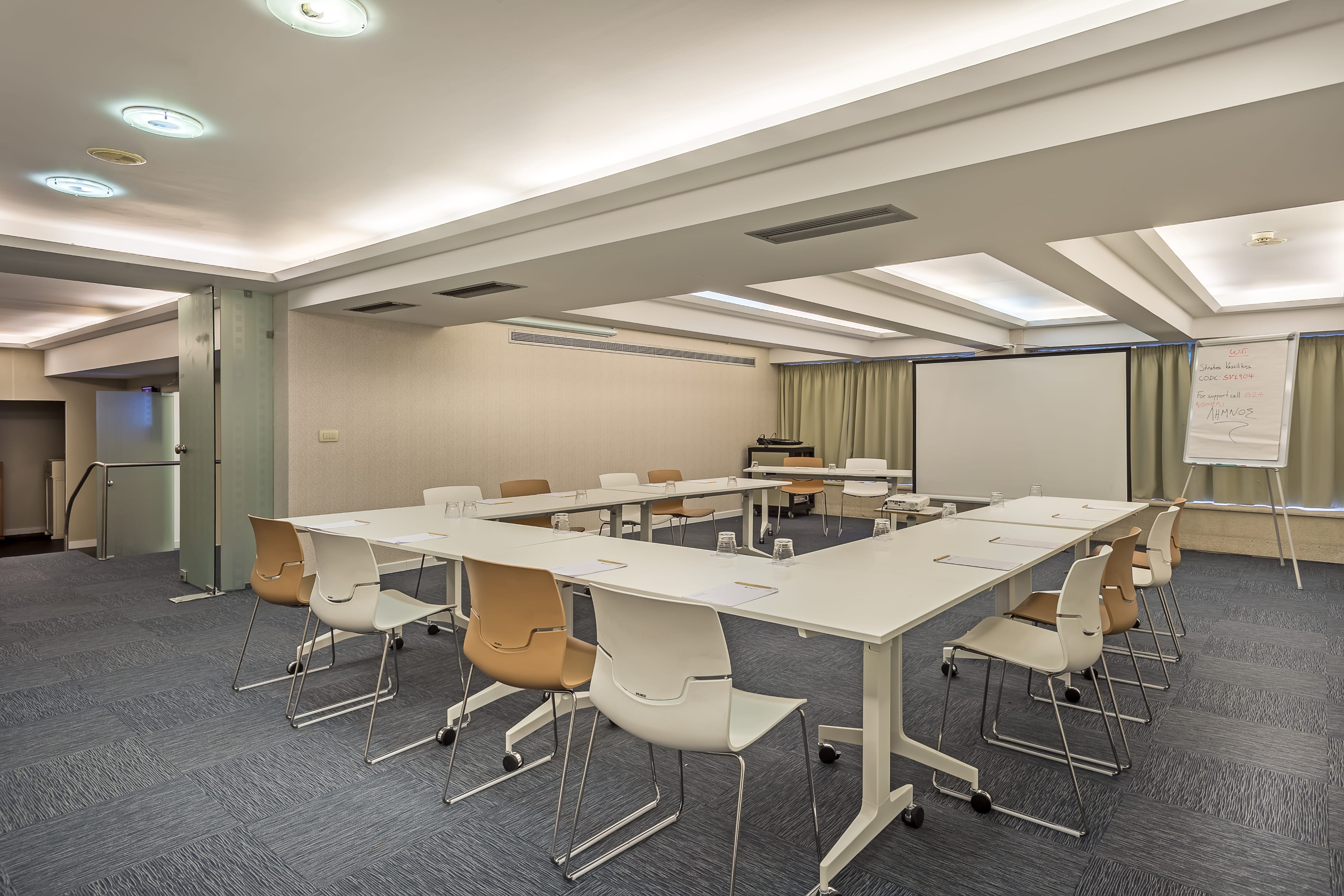 a room with a white board and tables