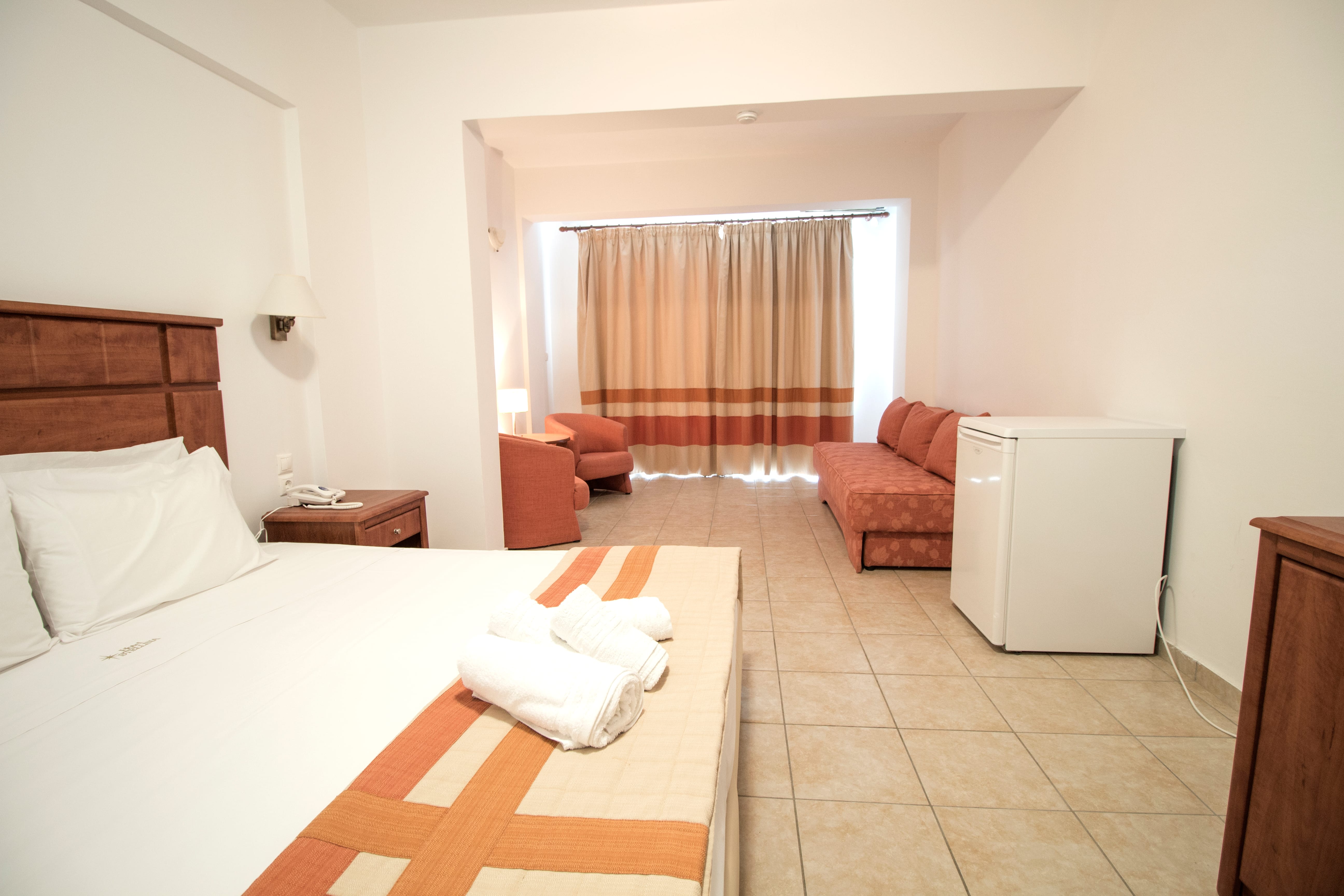 a hotel room with a bed and a couch