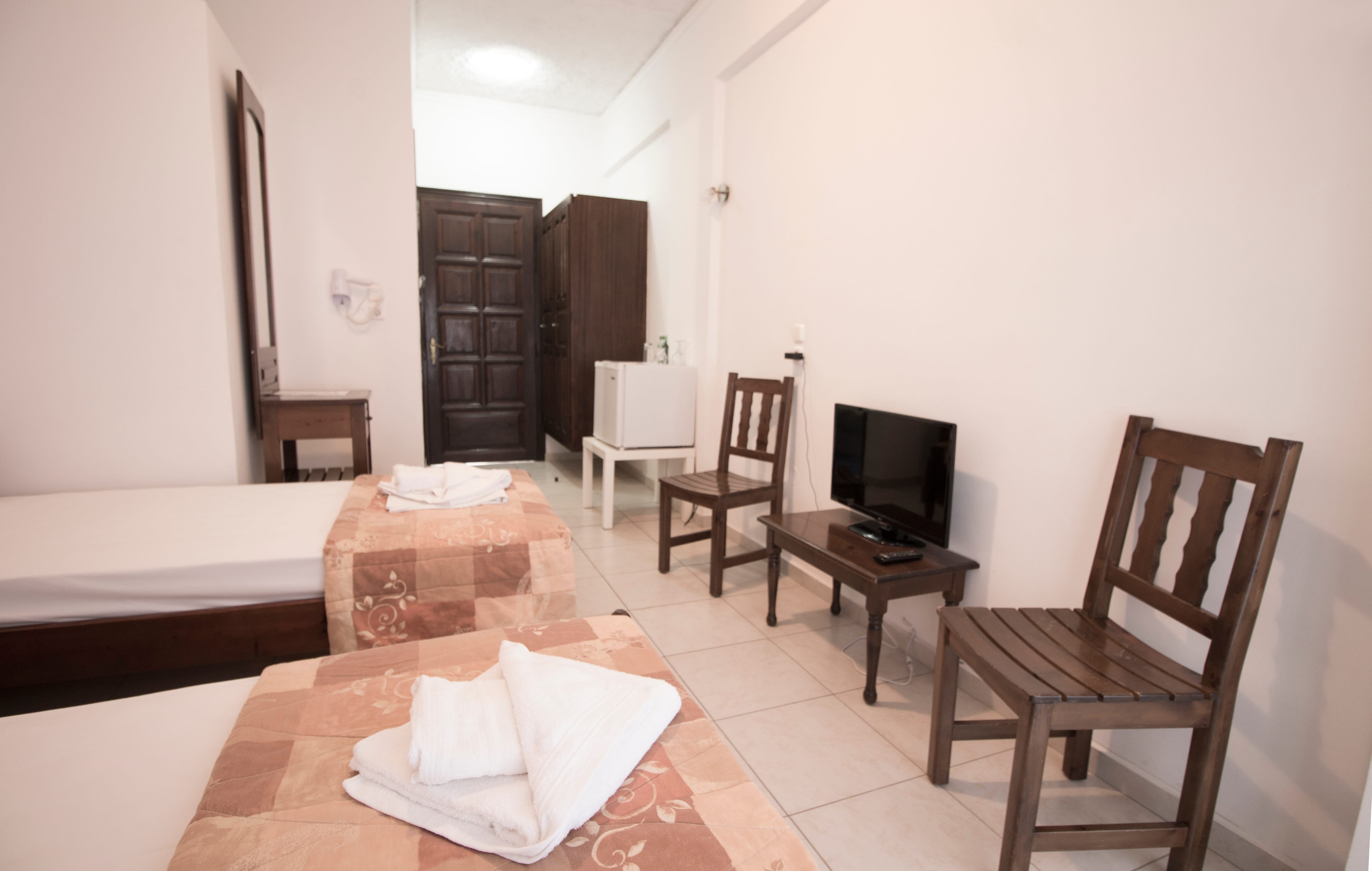a room with a television and chairs