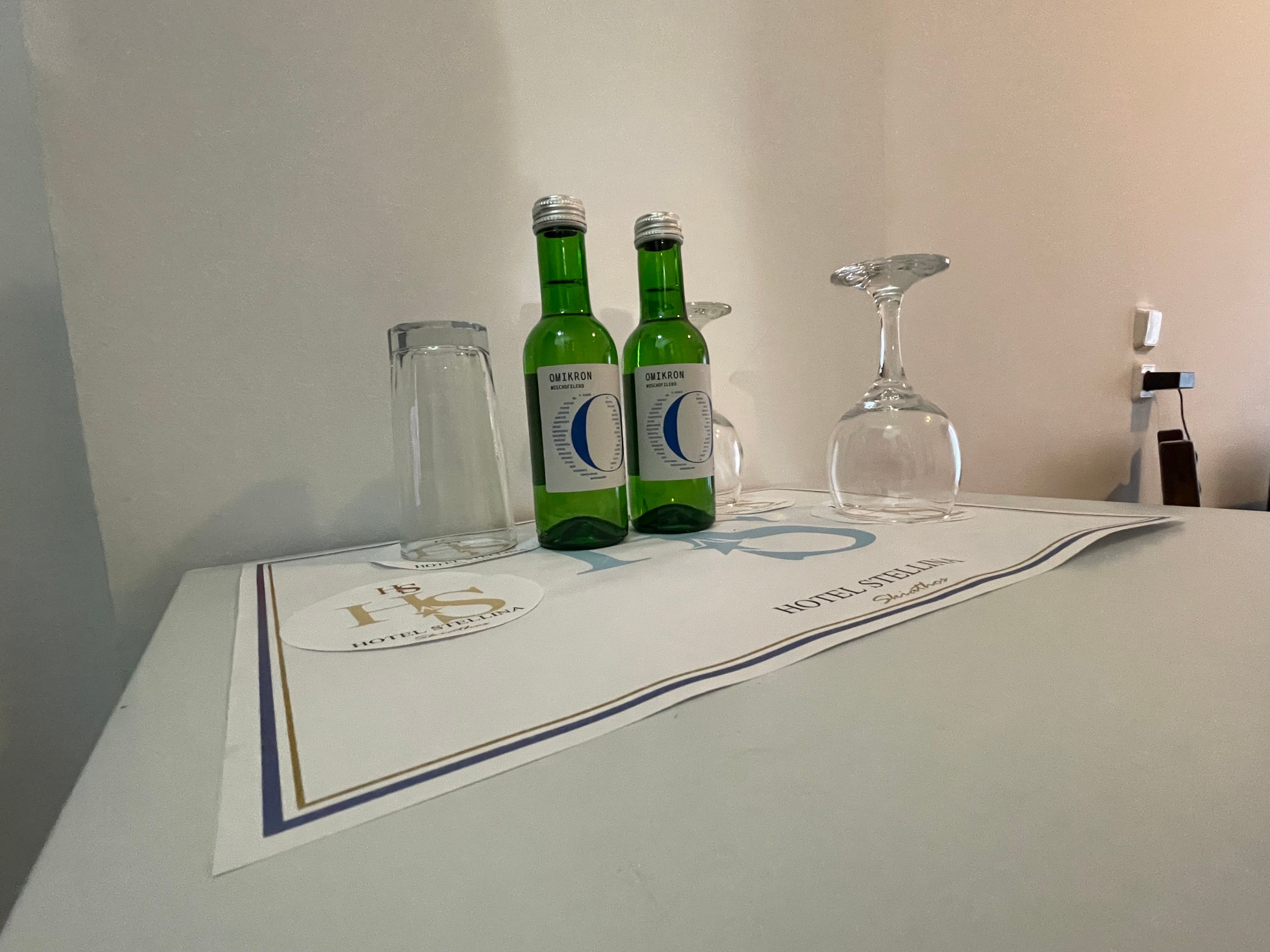 a group of green bottles and glasses on a table
