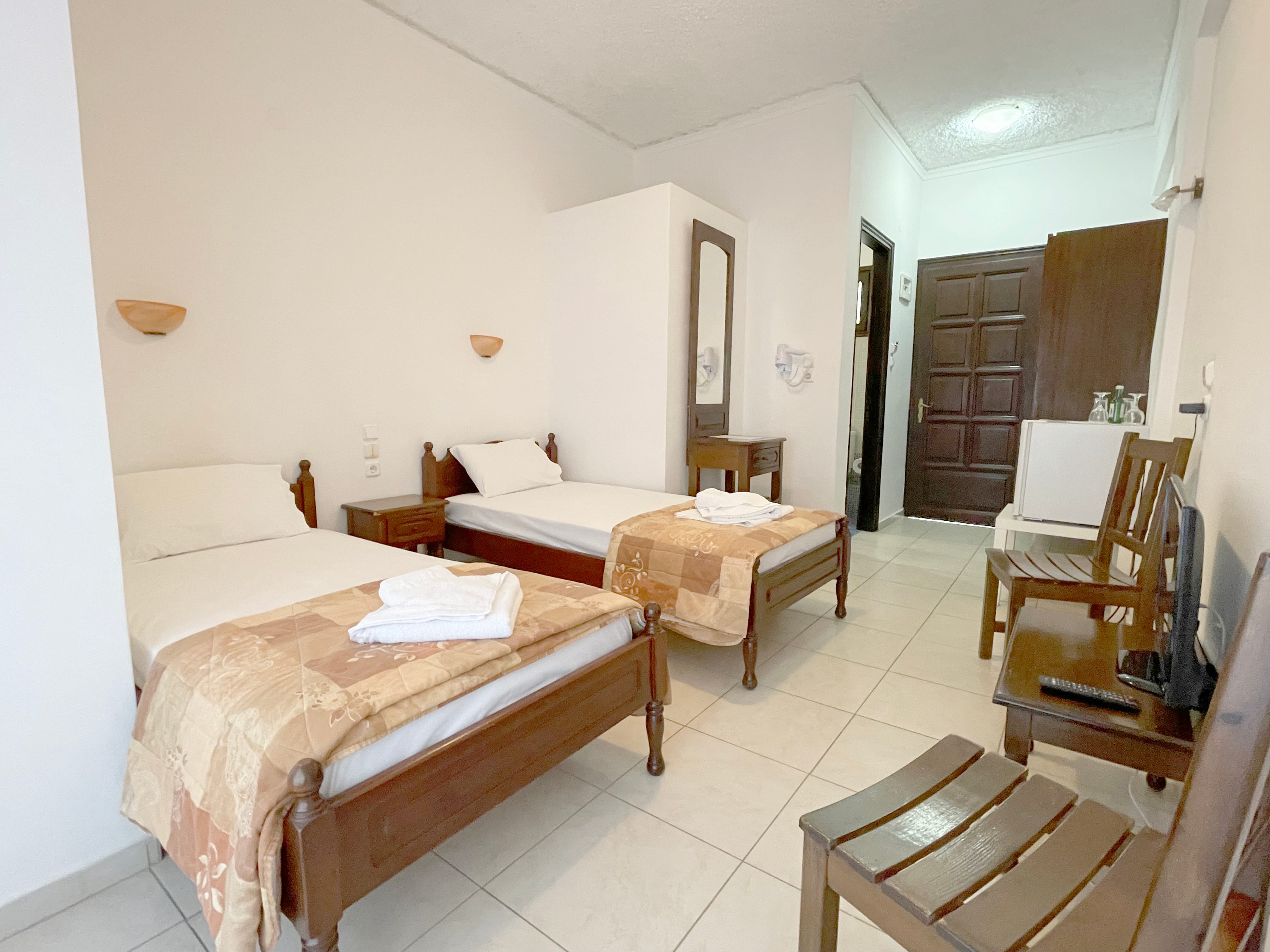 a room with two beds and a table