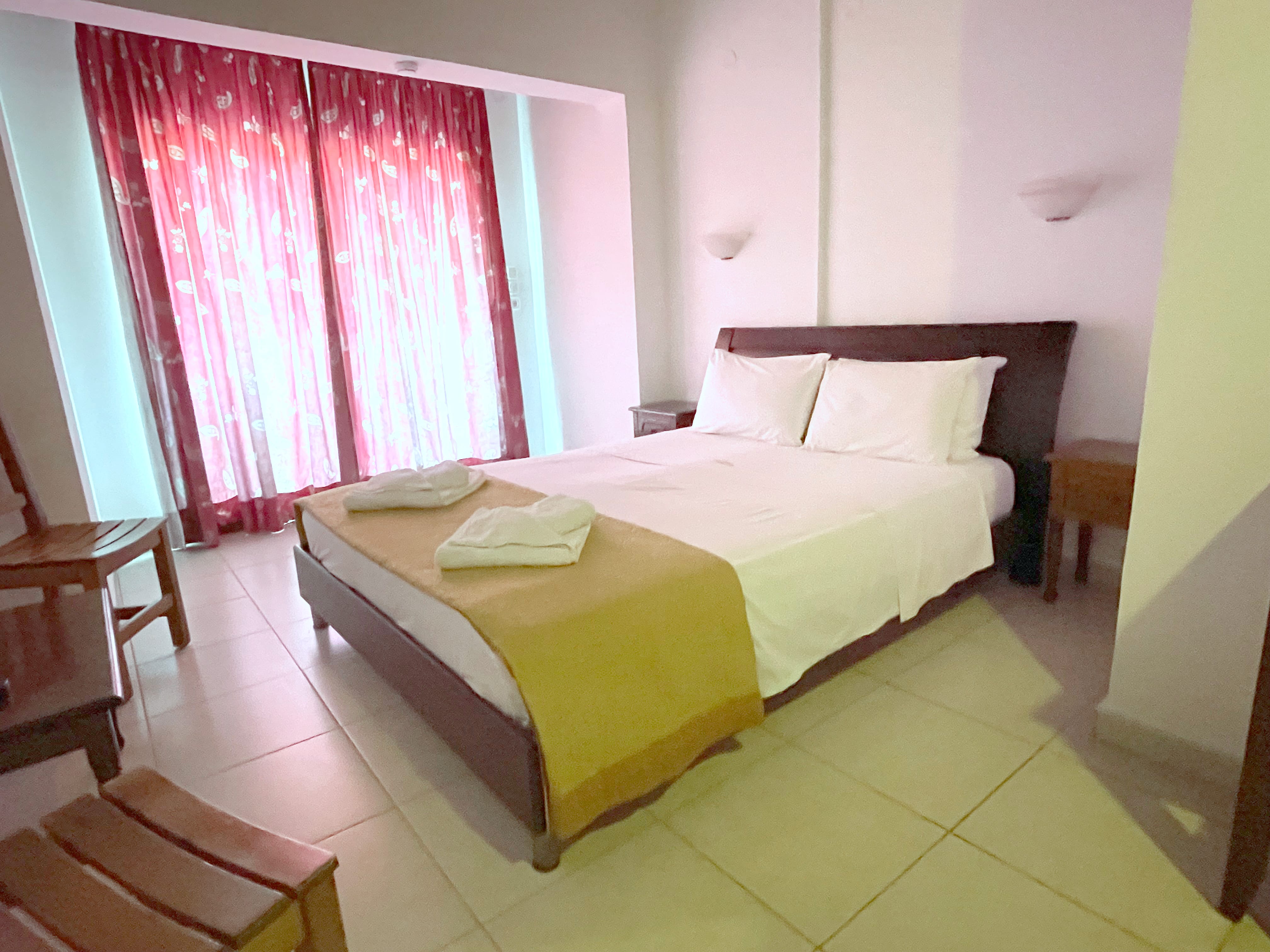 a bedroom with a bed and chairs