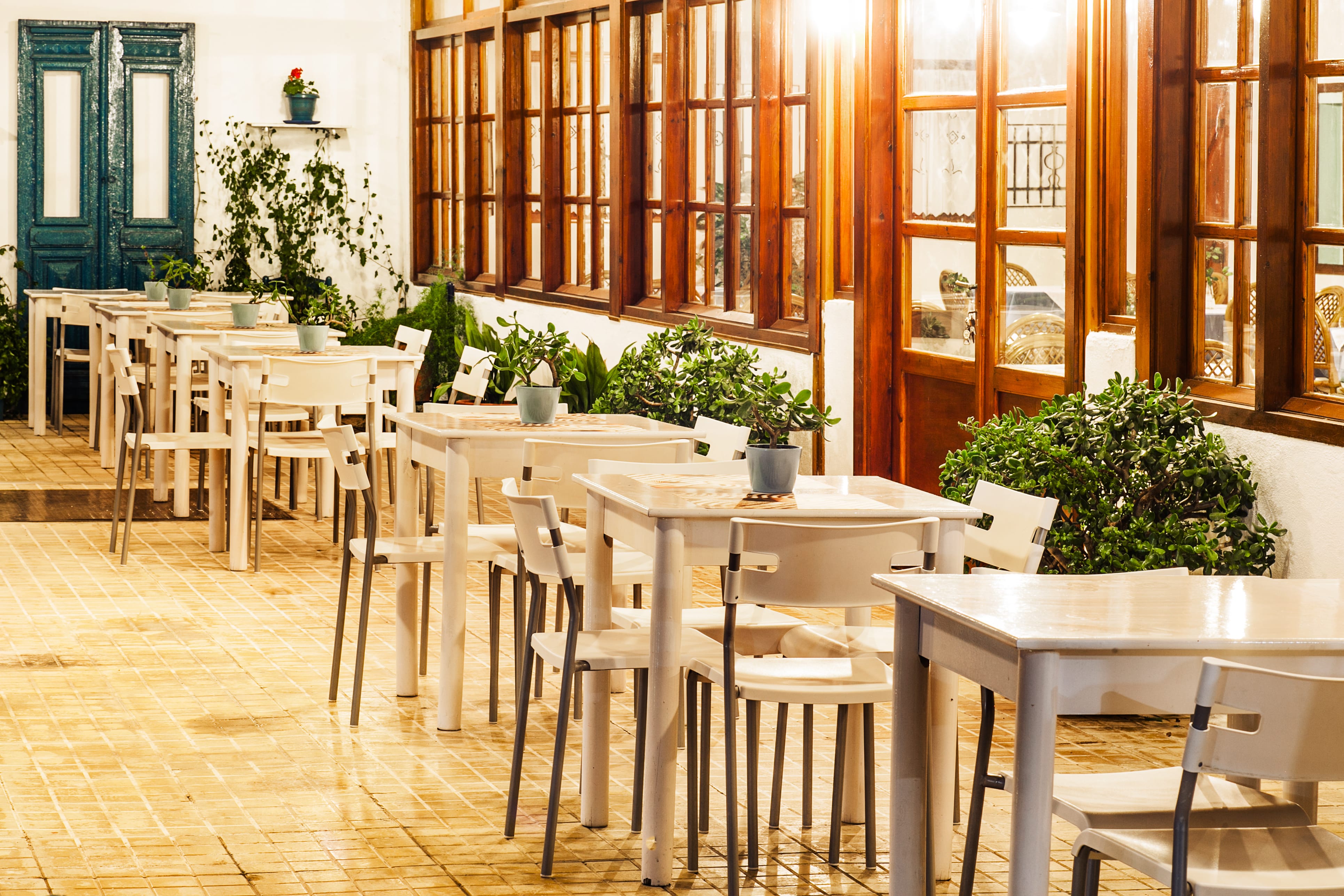 a group of tables and chairs outside a building