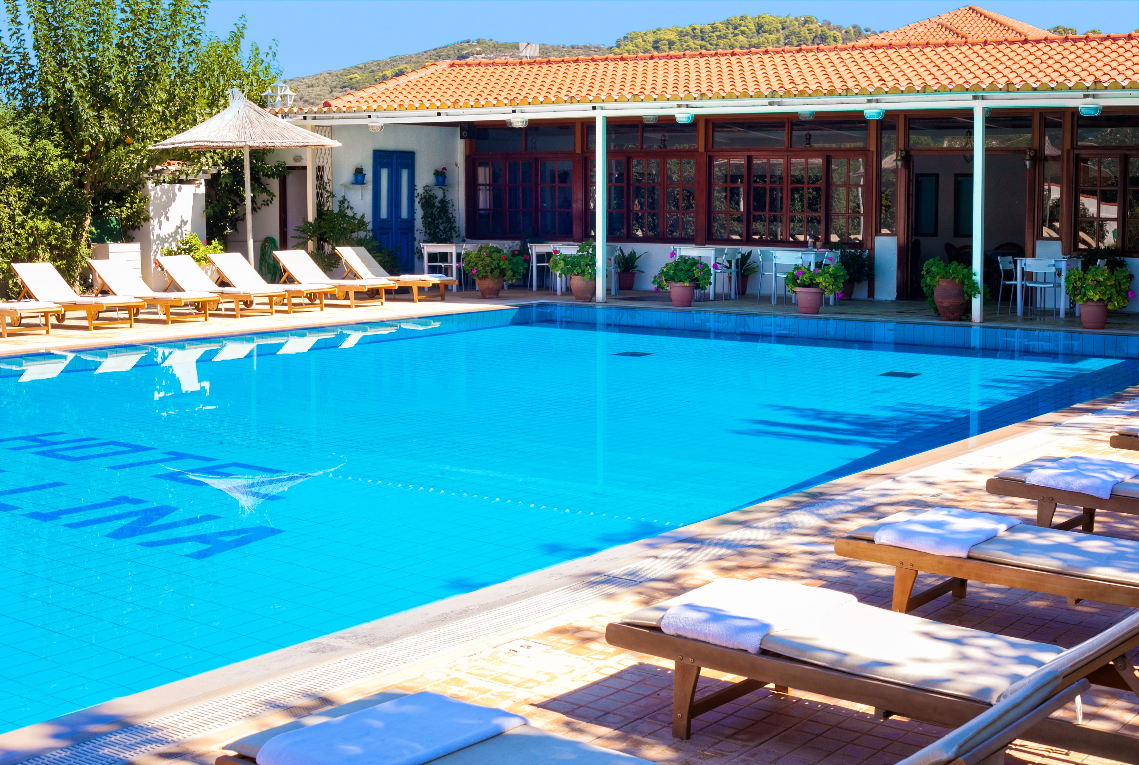 a swimming pool with lounge chairs