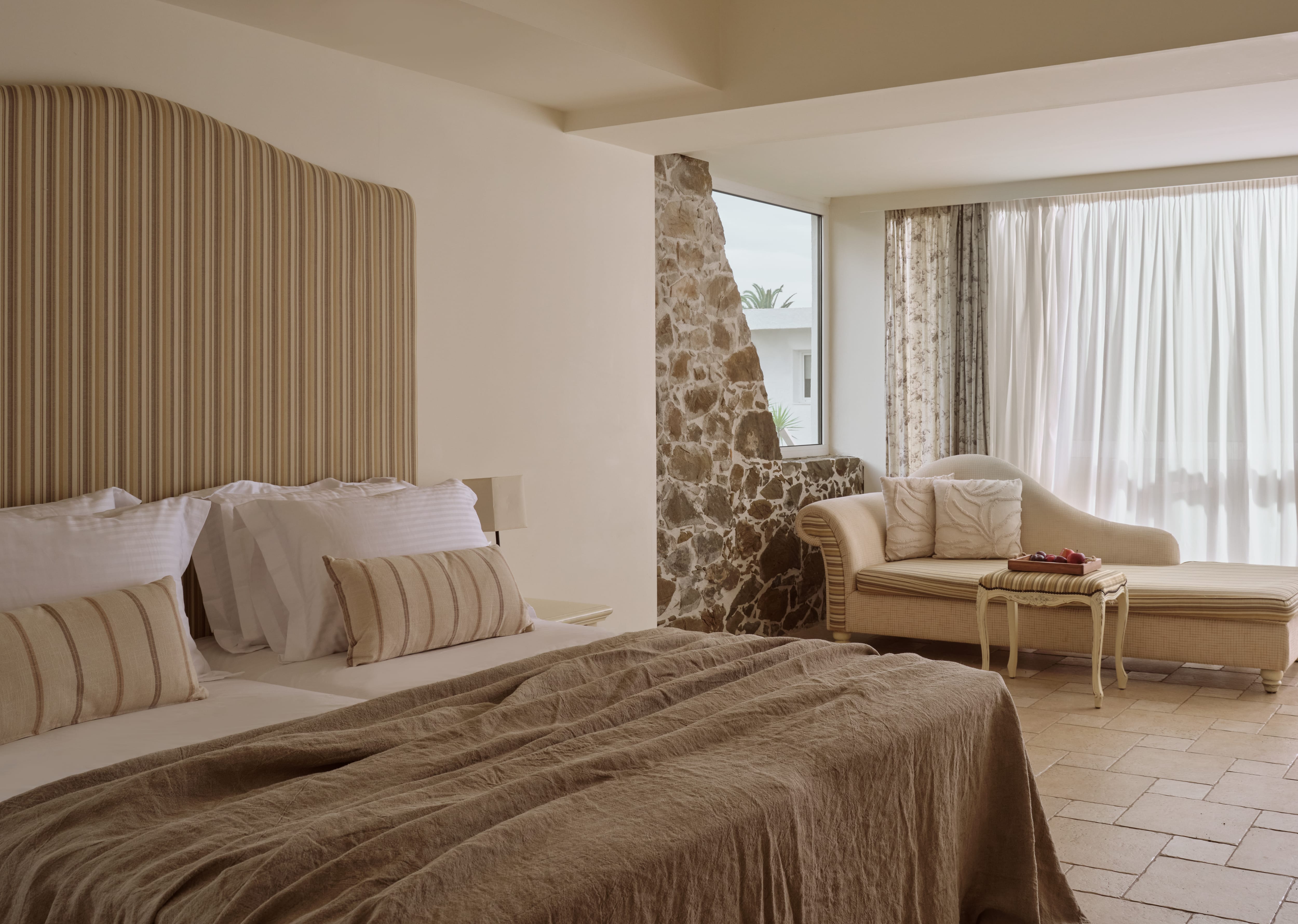 a bedroom with a bed and a couch