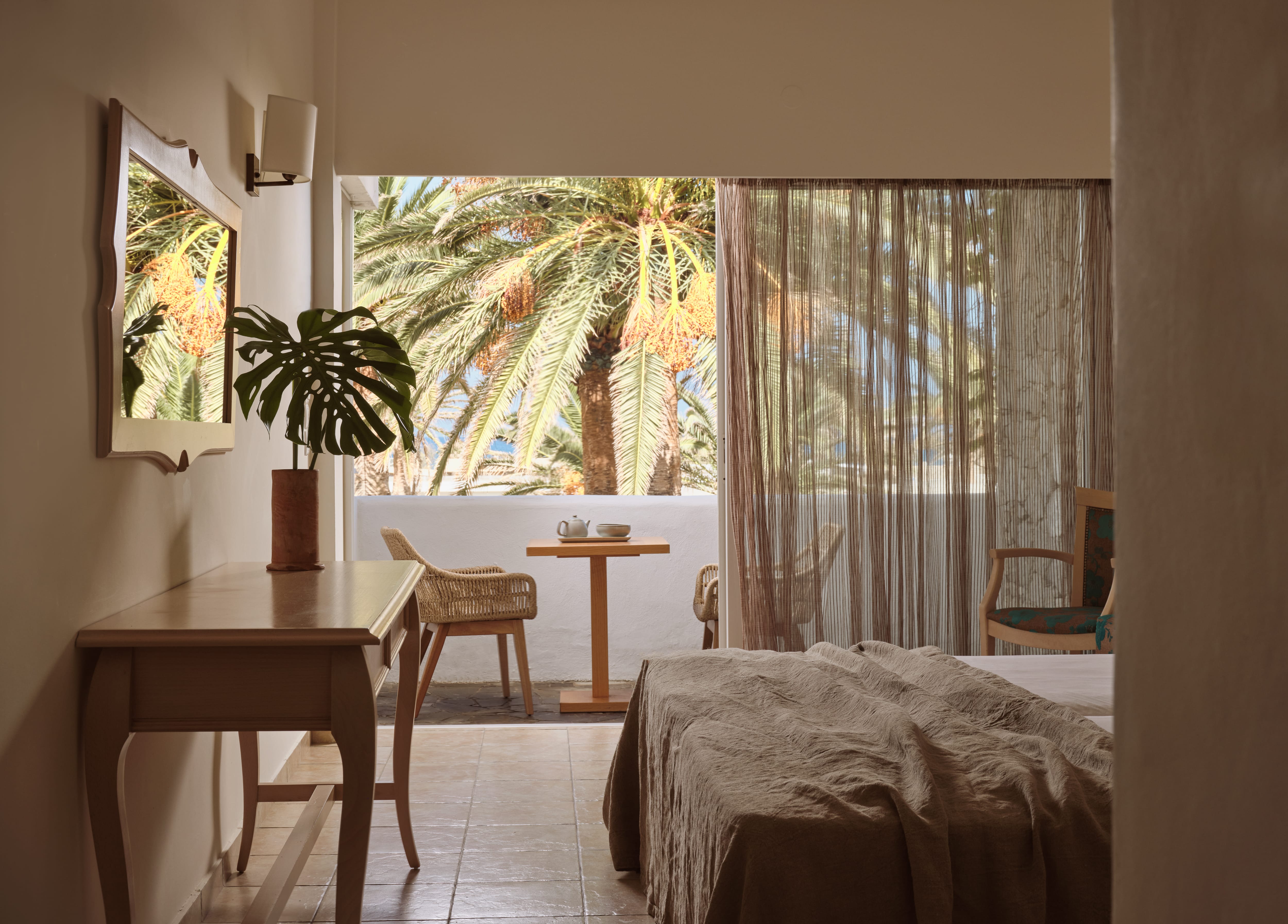 a bedroom with a bed and a table and chairs