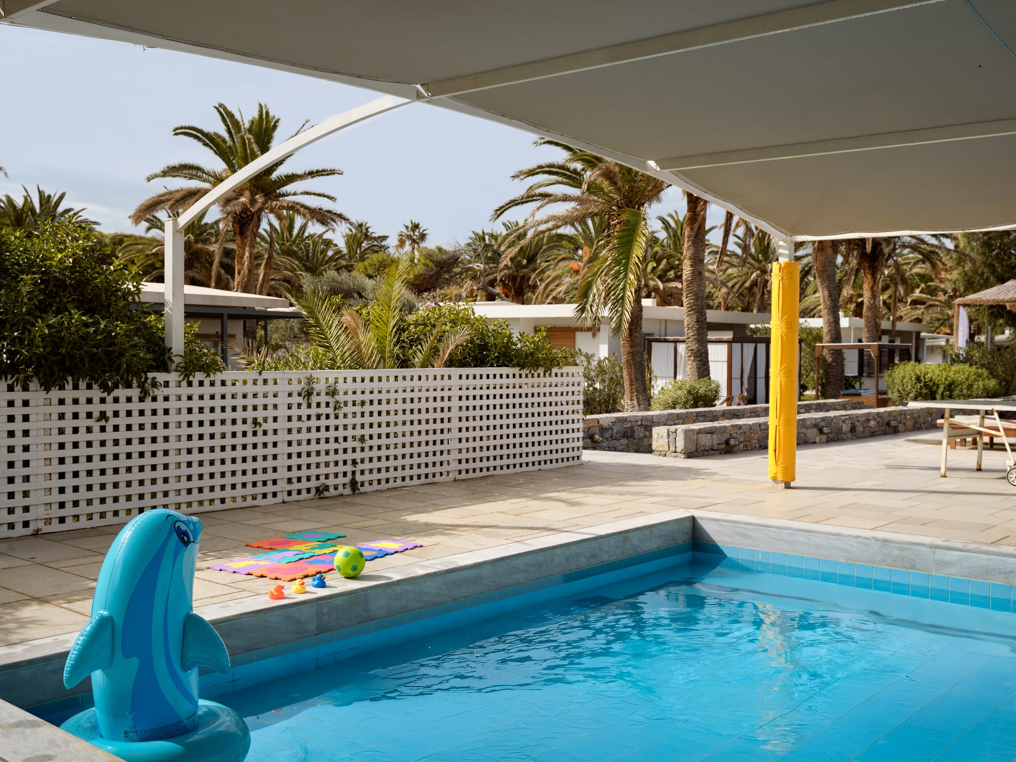 a pool with a slide and a child in it