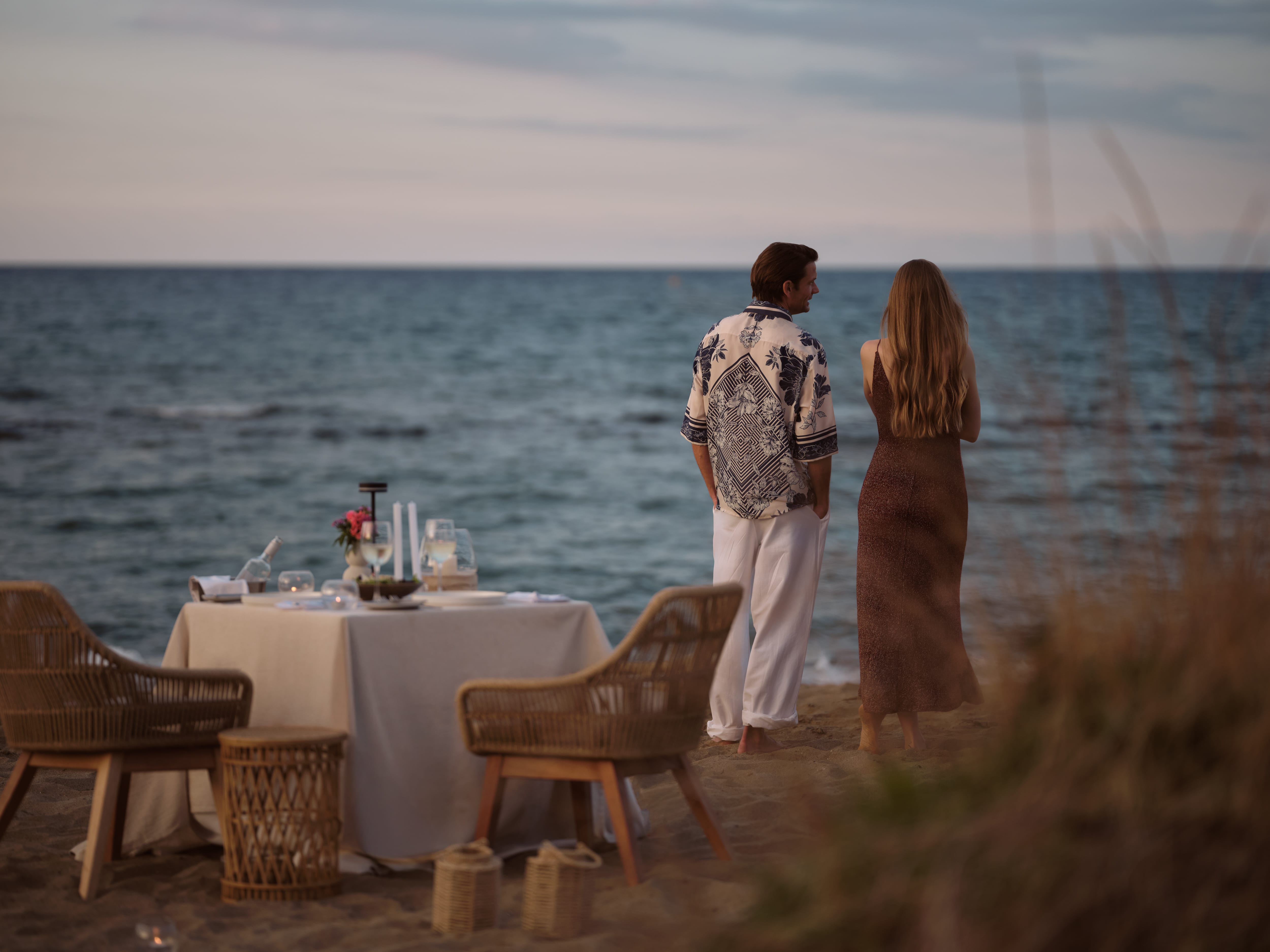 a person and person standing on a beach