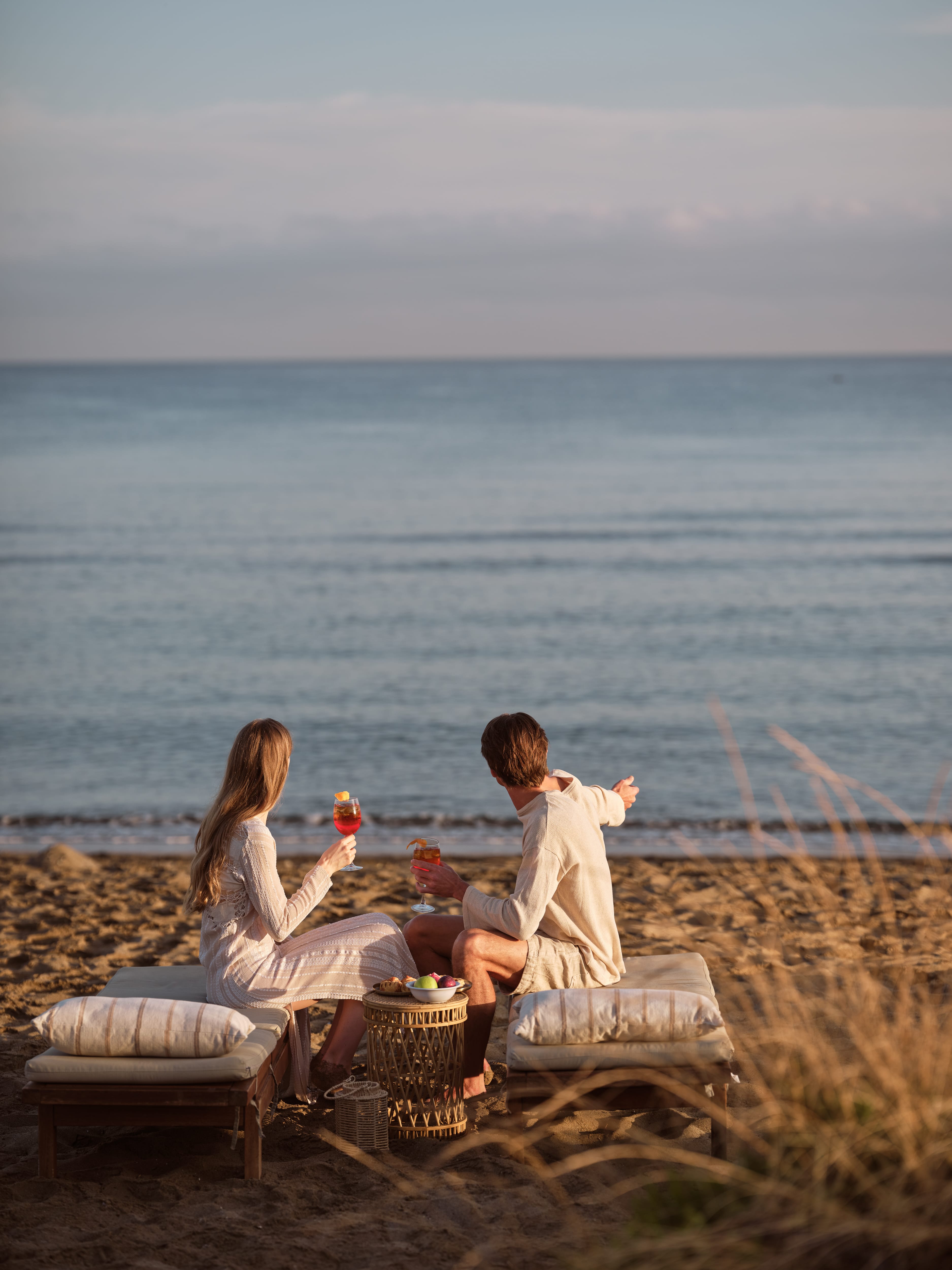 a person and person sitting on a beach