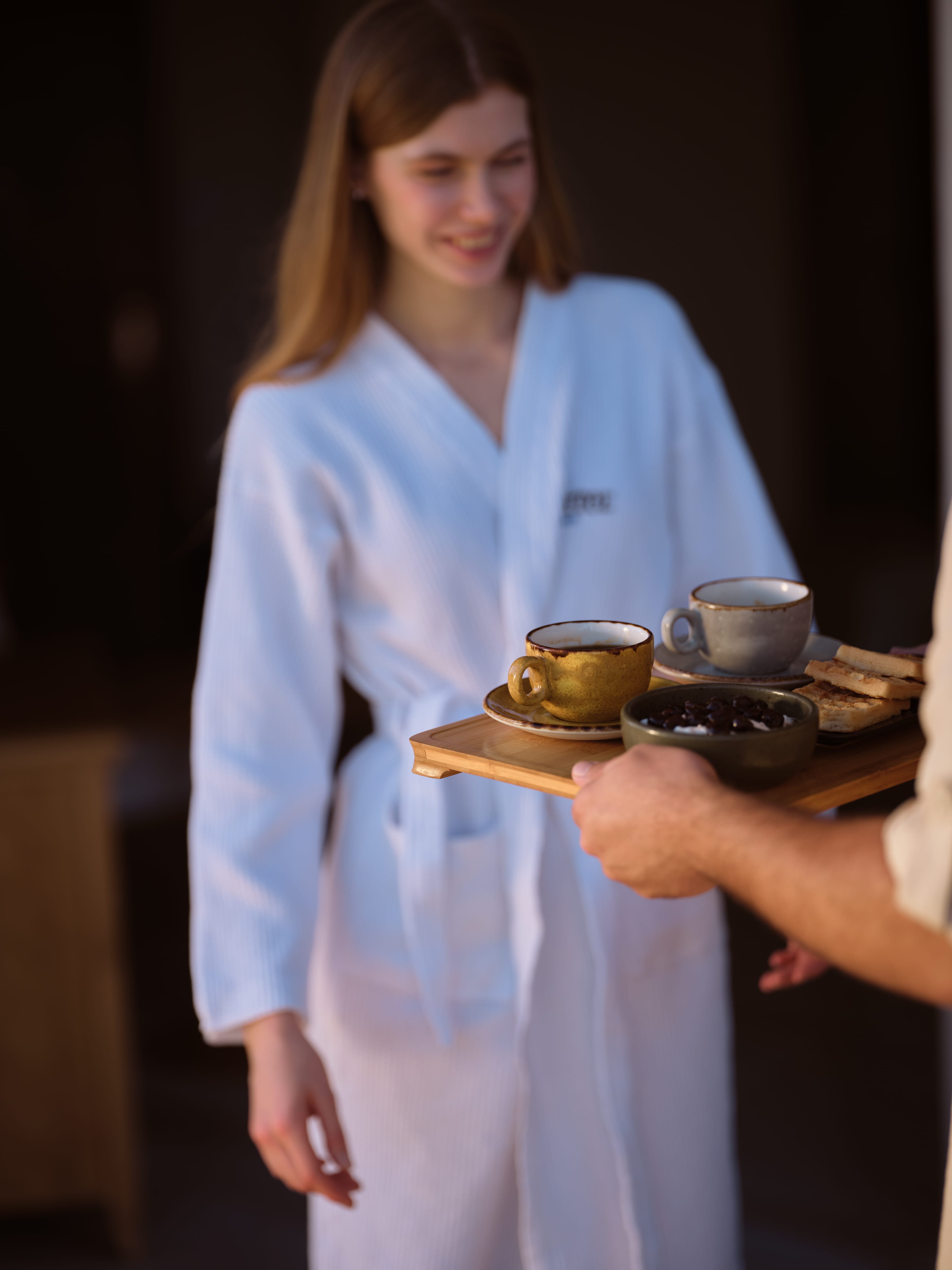 a person holding a tray of coffee cups