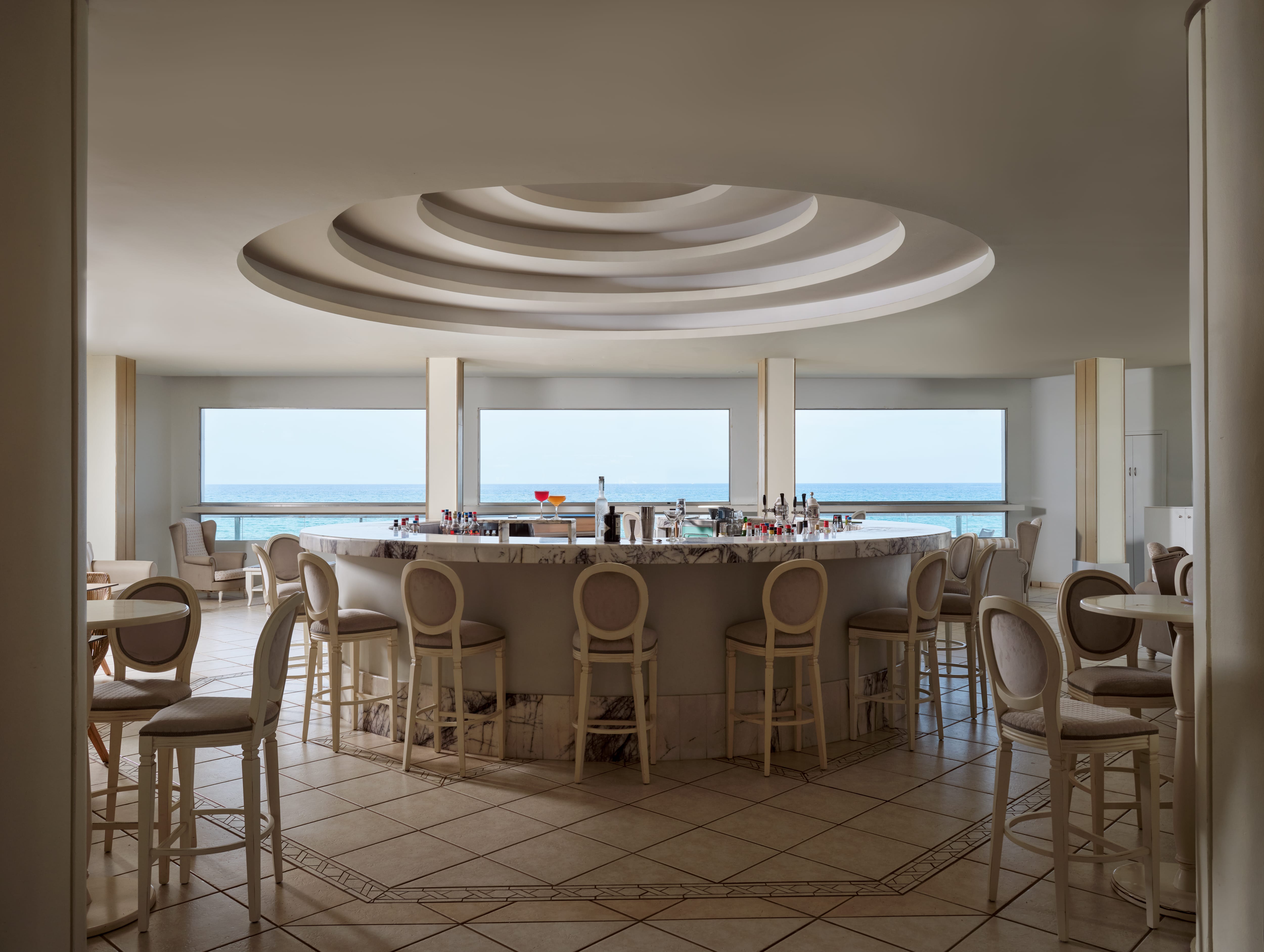 a room with a large round table and chairs