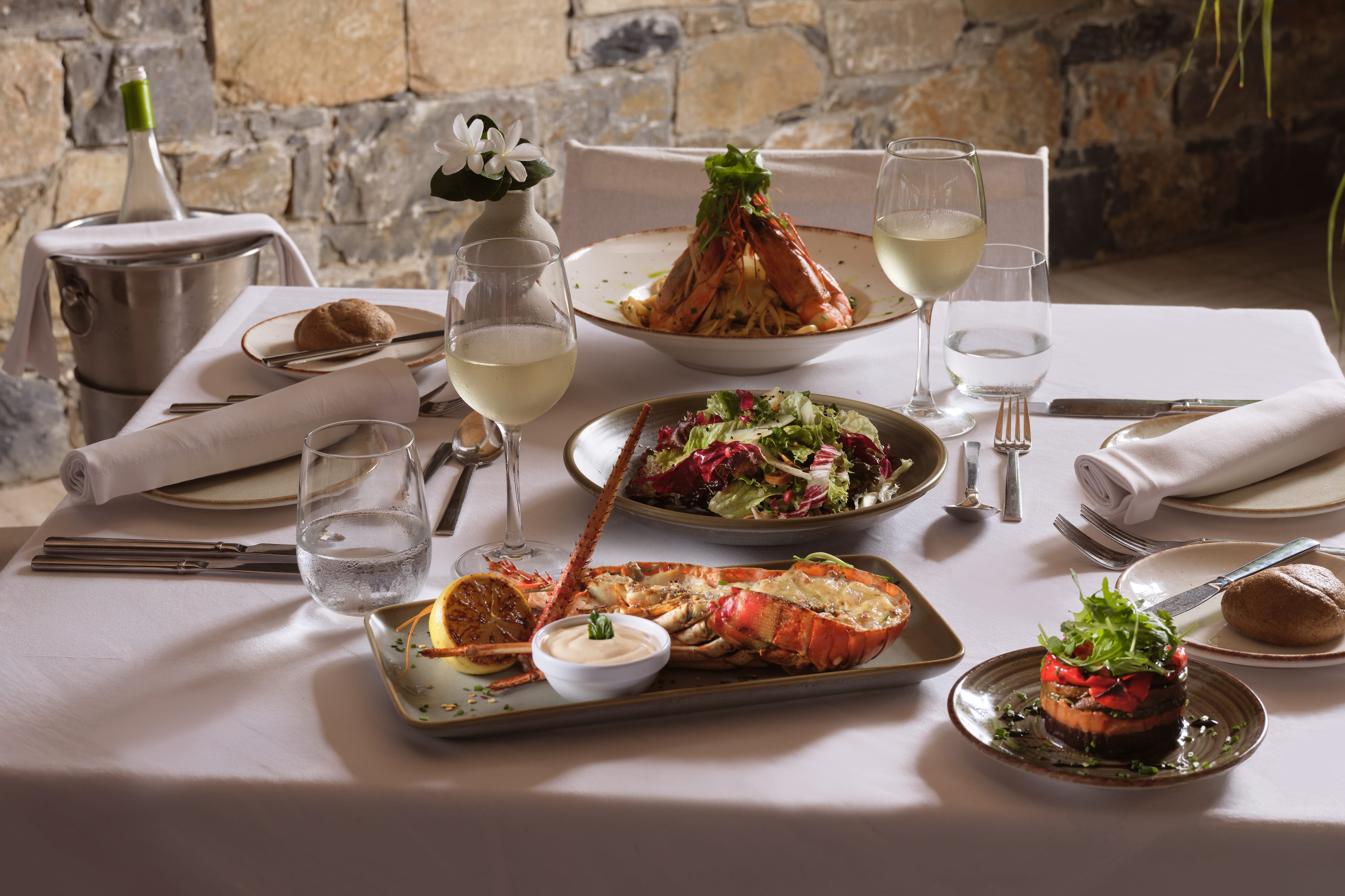 a table with plates of food and glasses