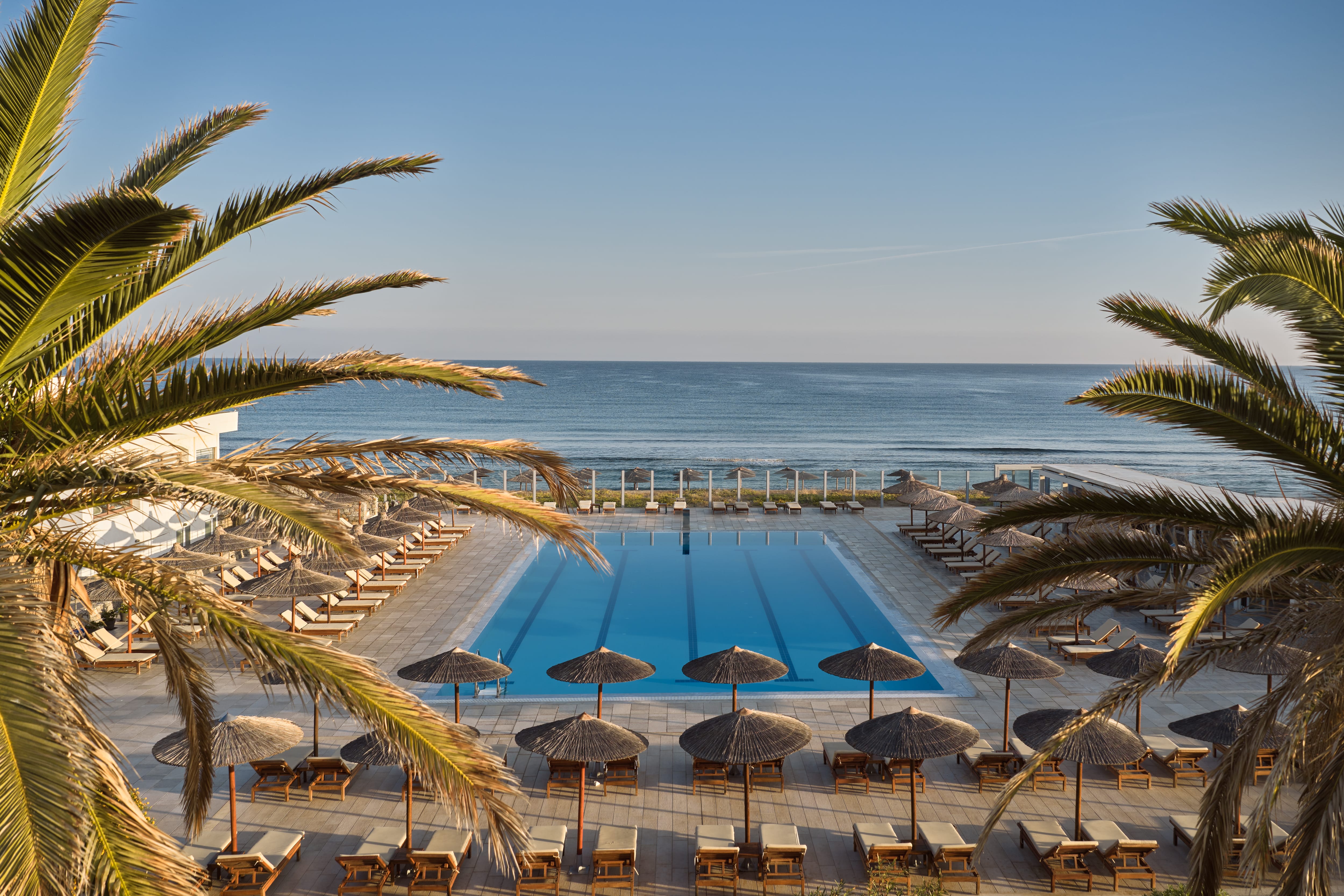 a pool with umbrellas and chairs