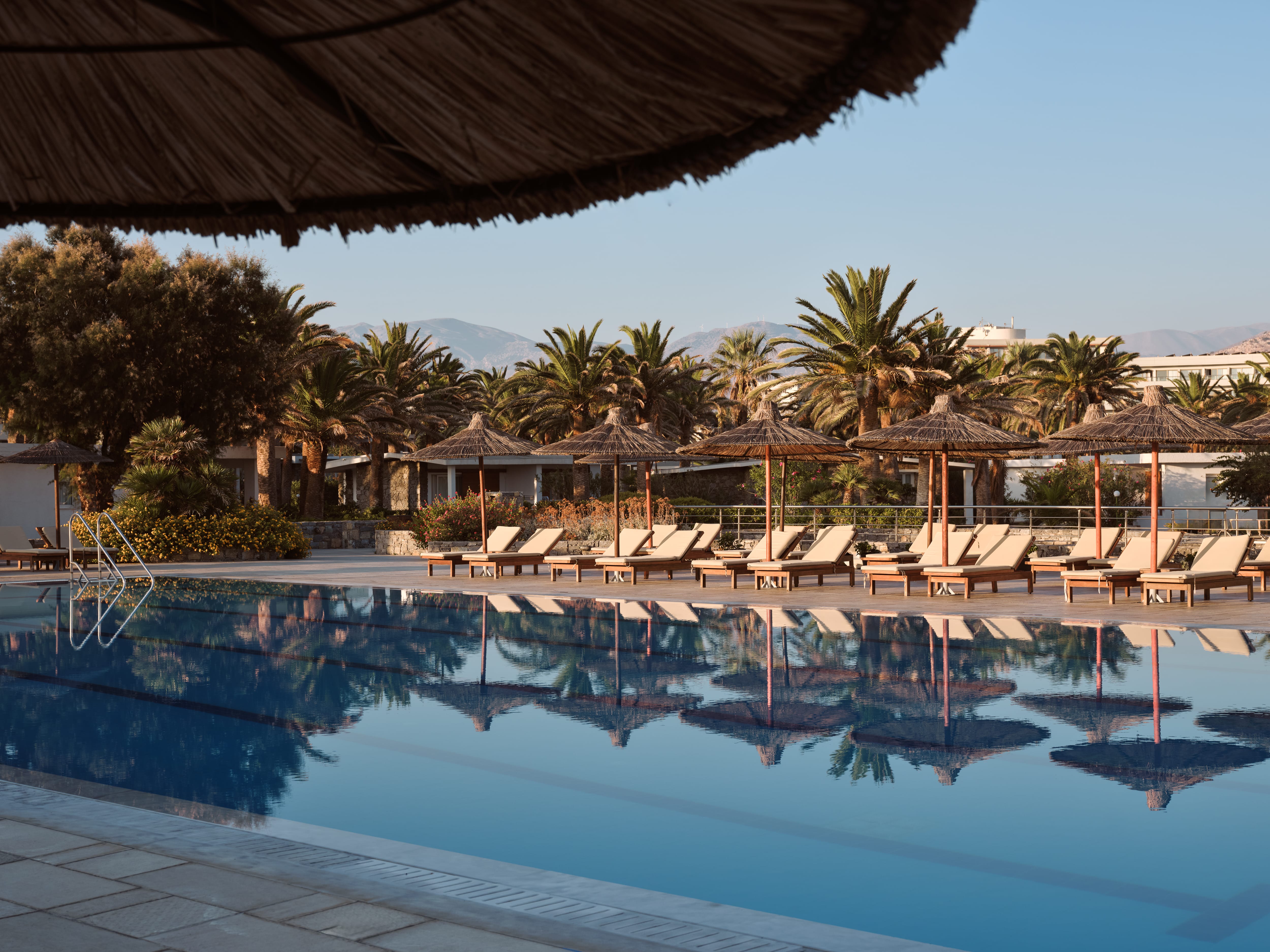 a pool with lounge chairs and umbrellas