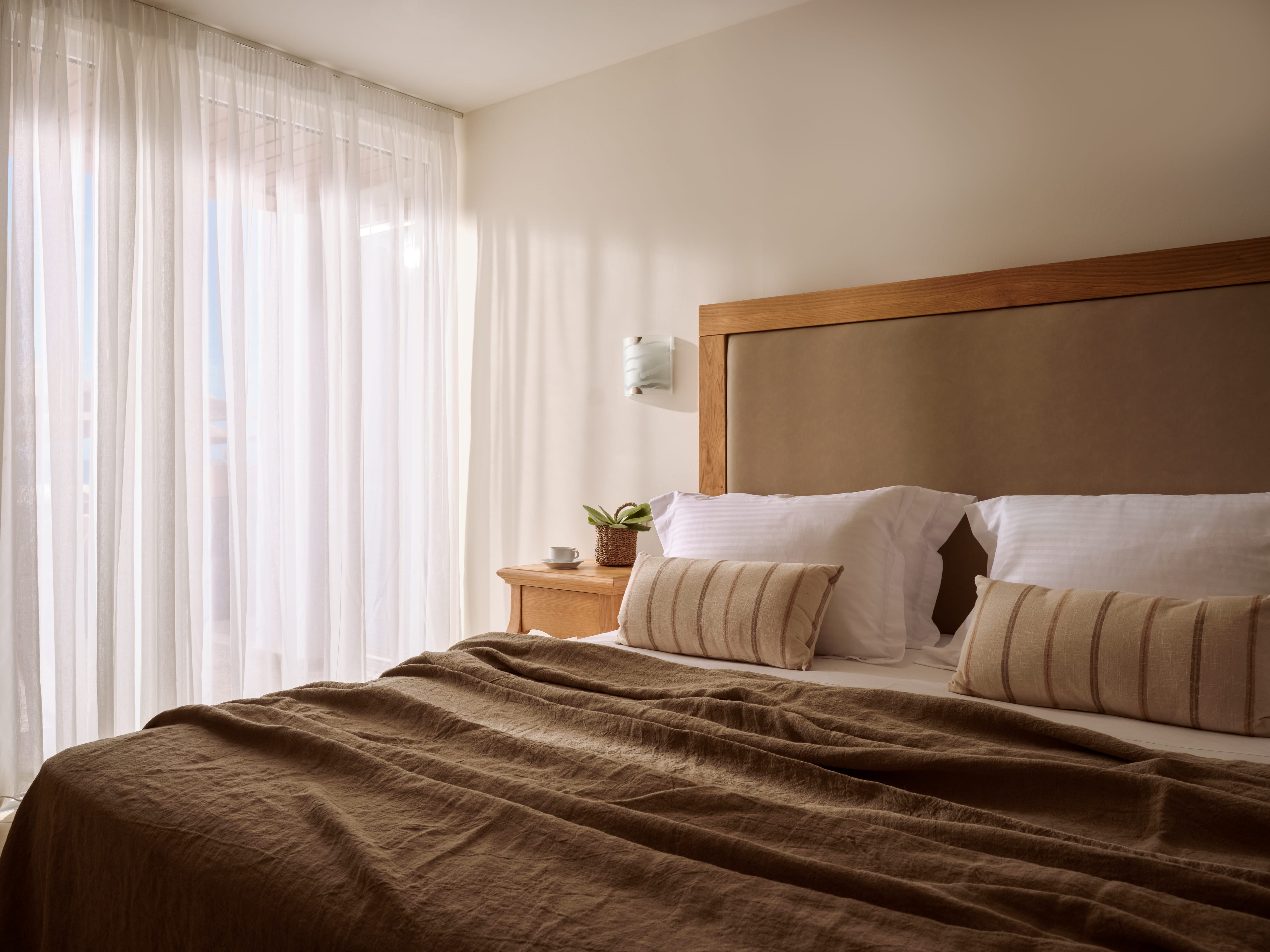 a bed with brown blanket and pillows