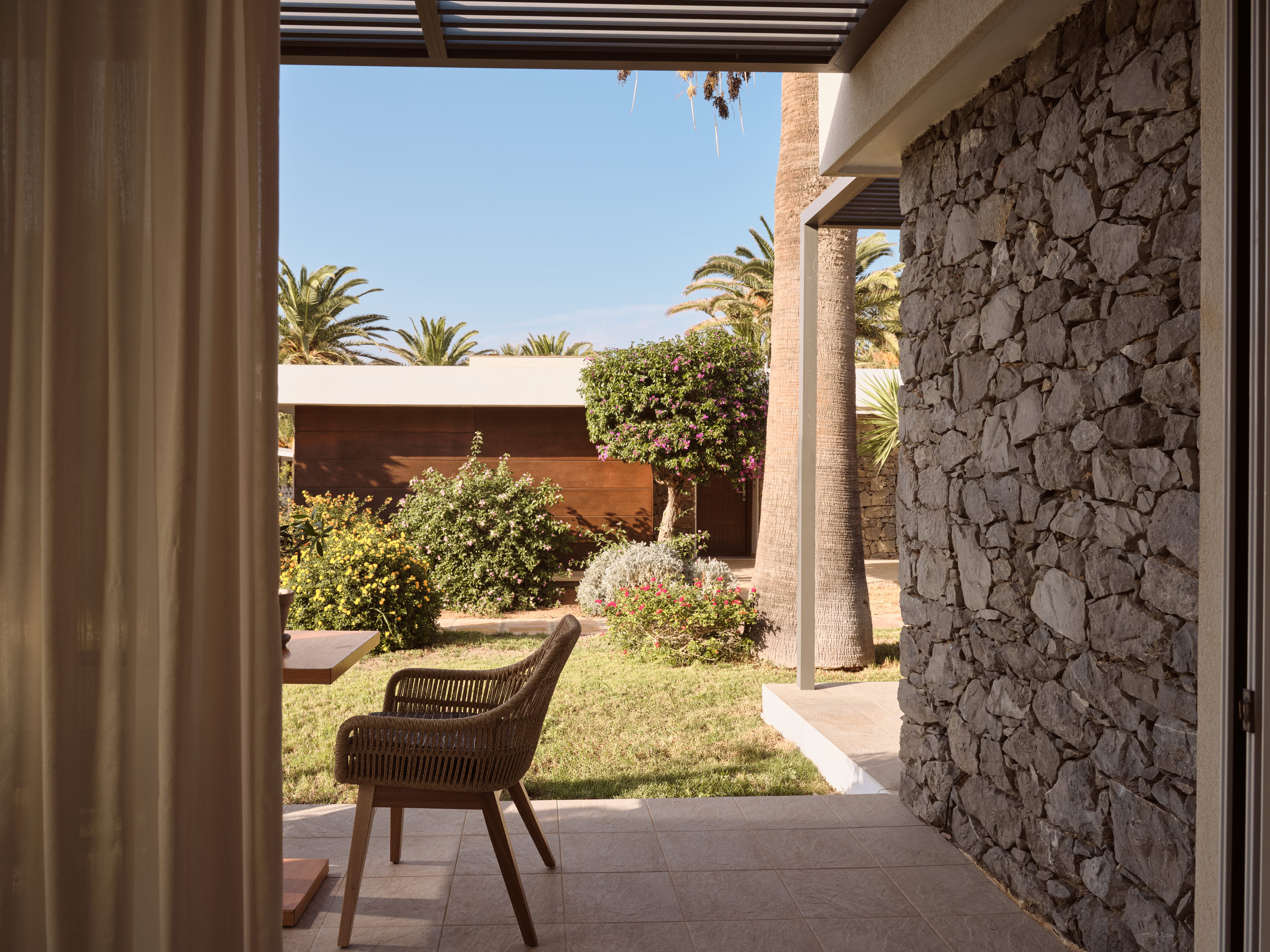 a patio with a chair and a table