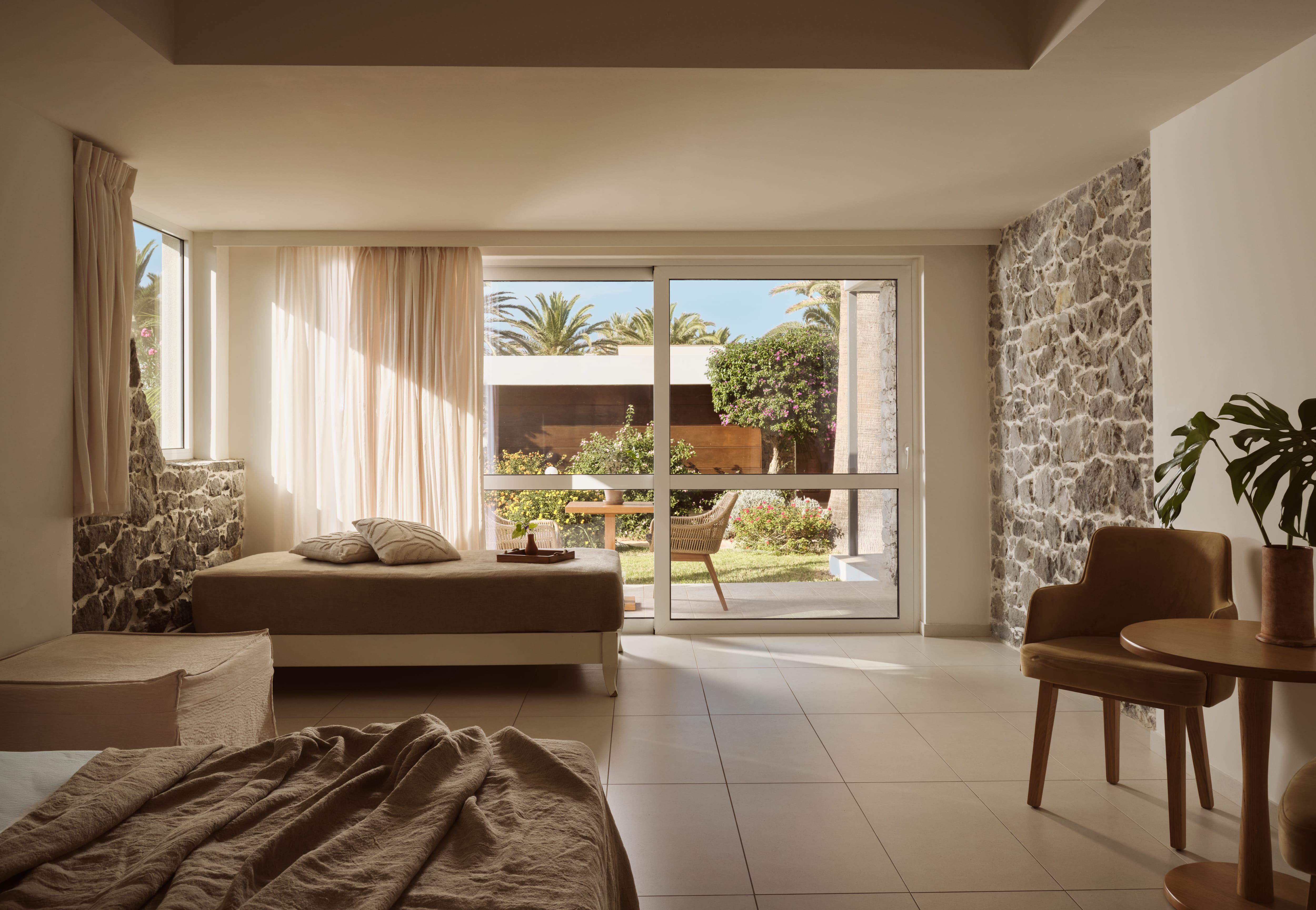 a bedroom with a stone wall and a bed