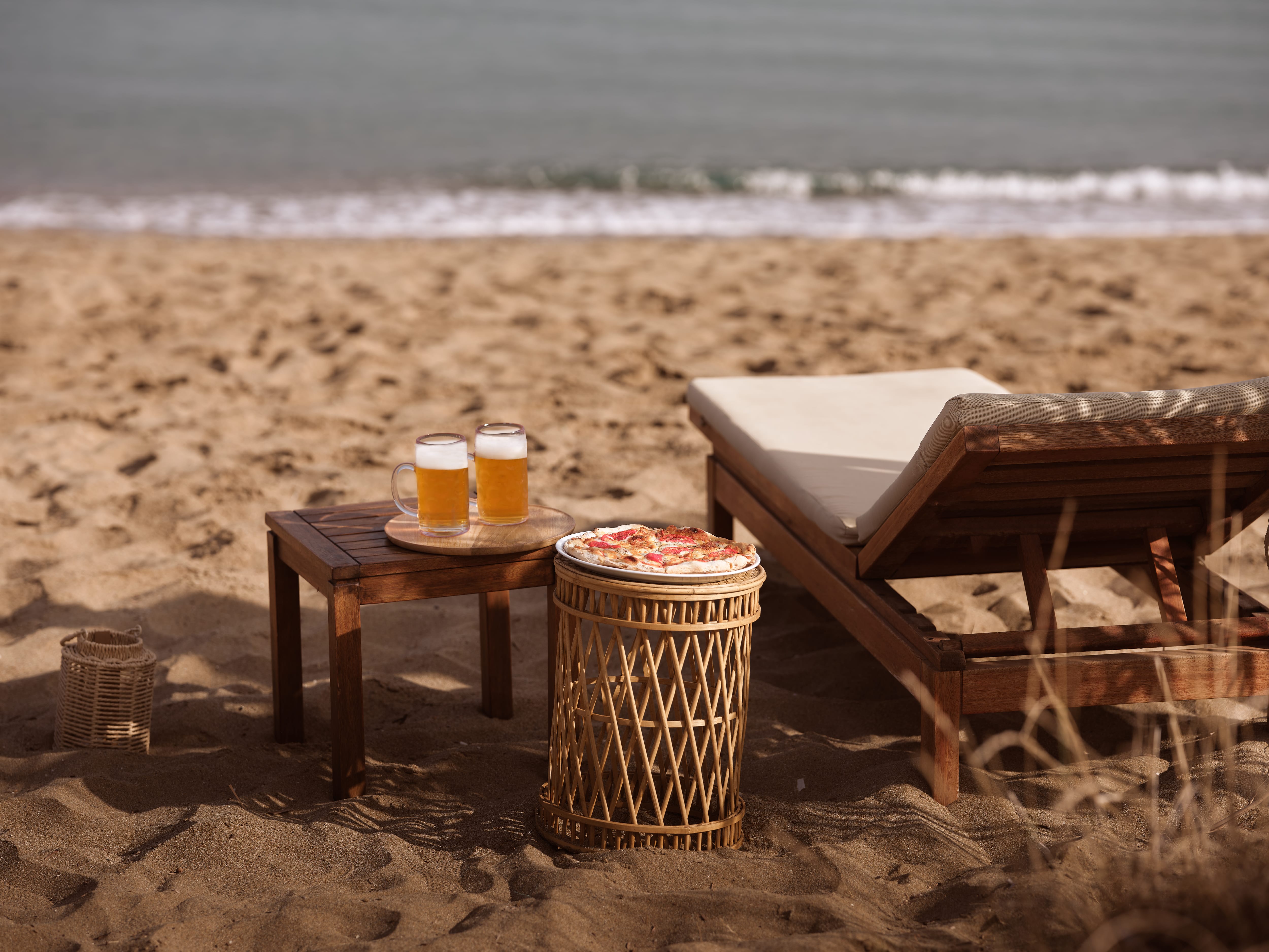 a table and a chair on a beach