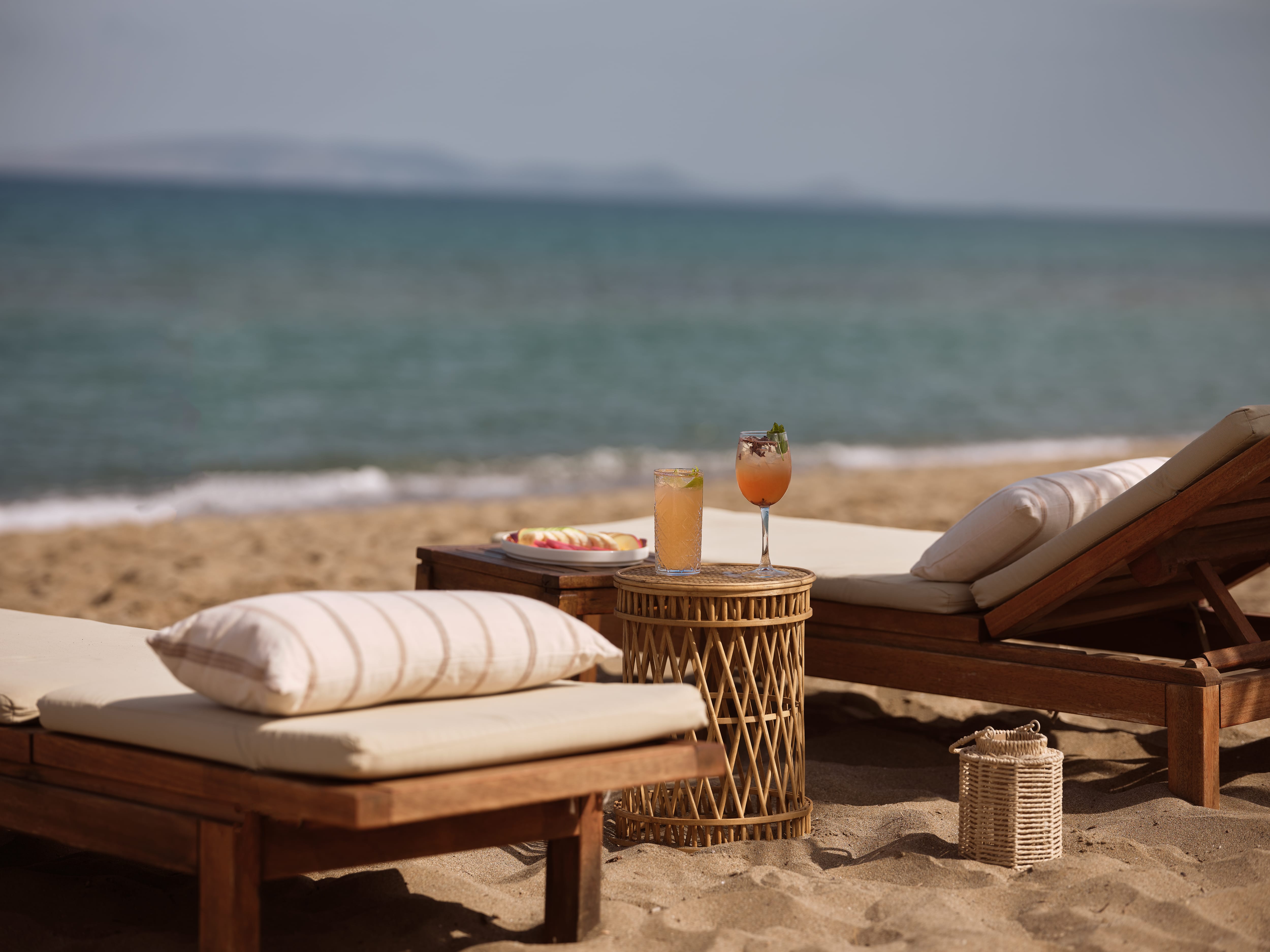a table and chairs on a beach