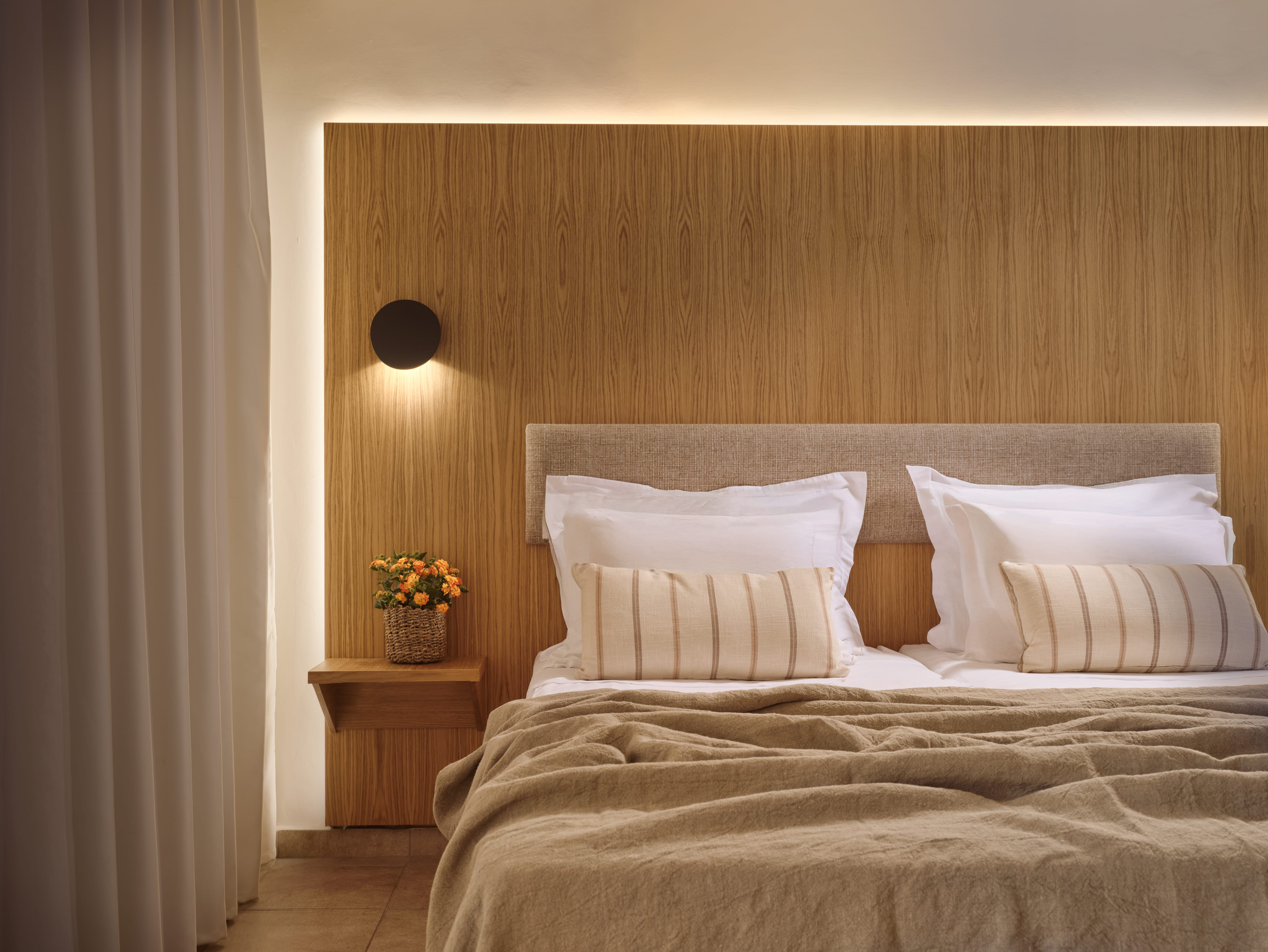a bed with pillows and a lamp