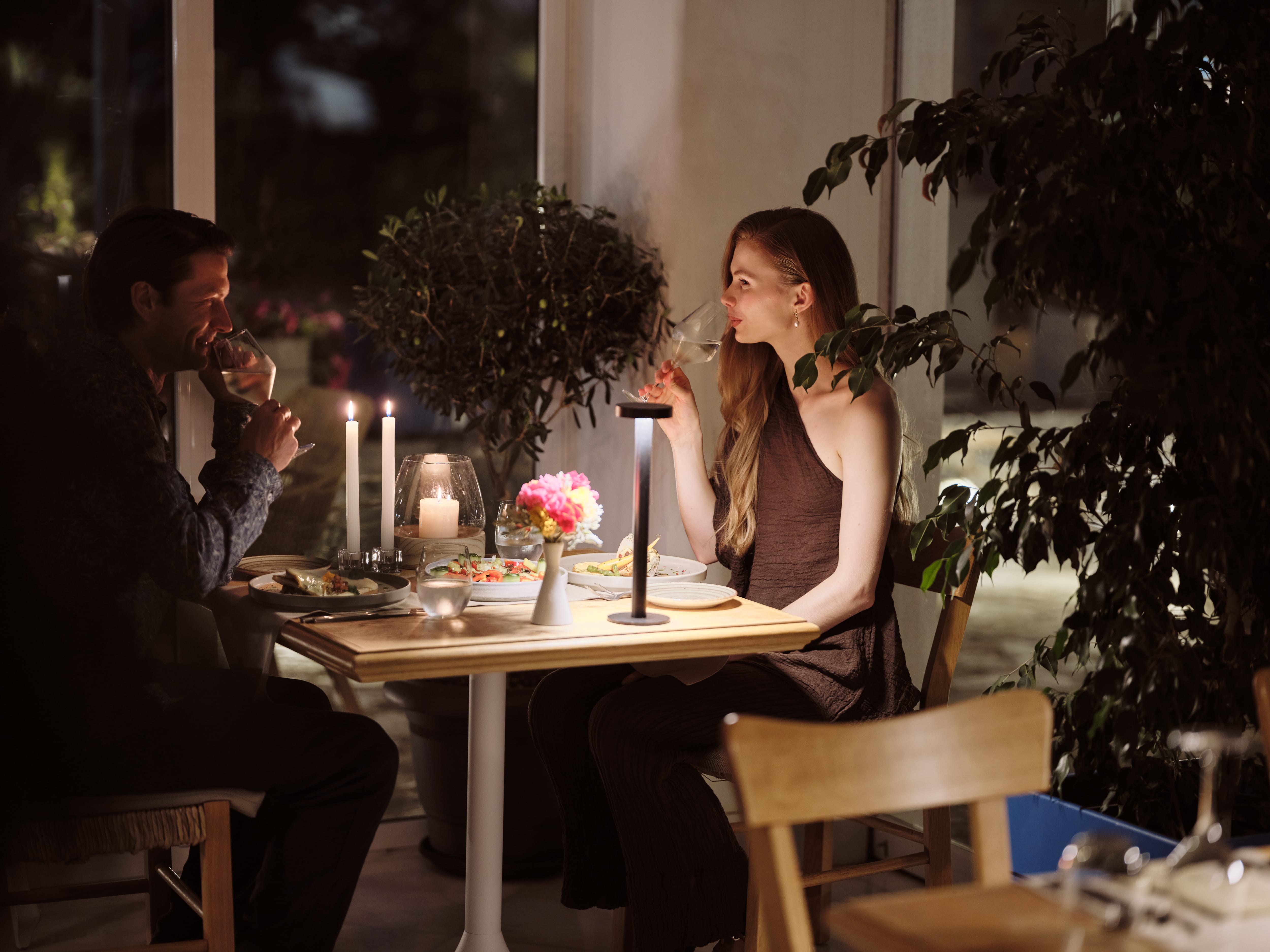 a person and person sitting at a table