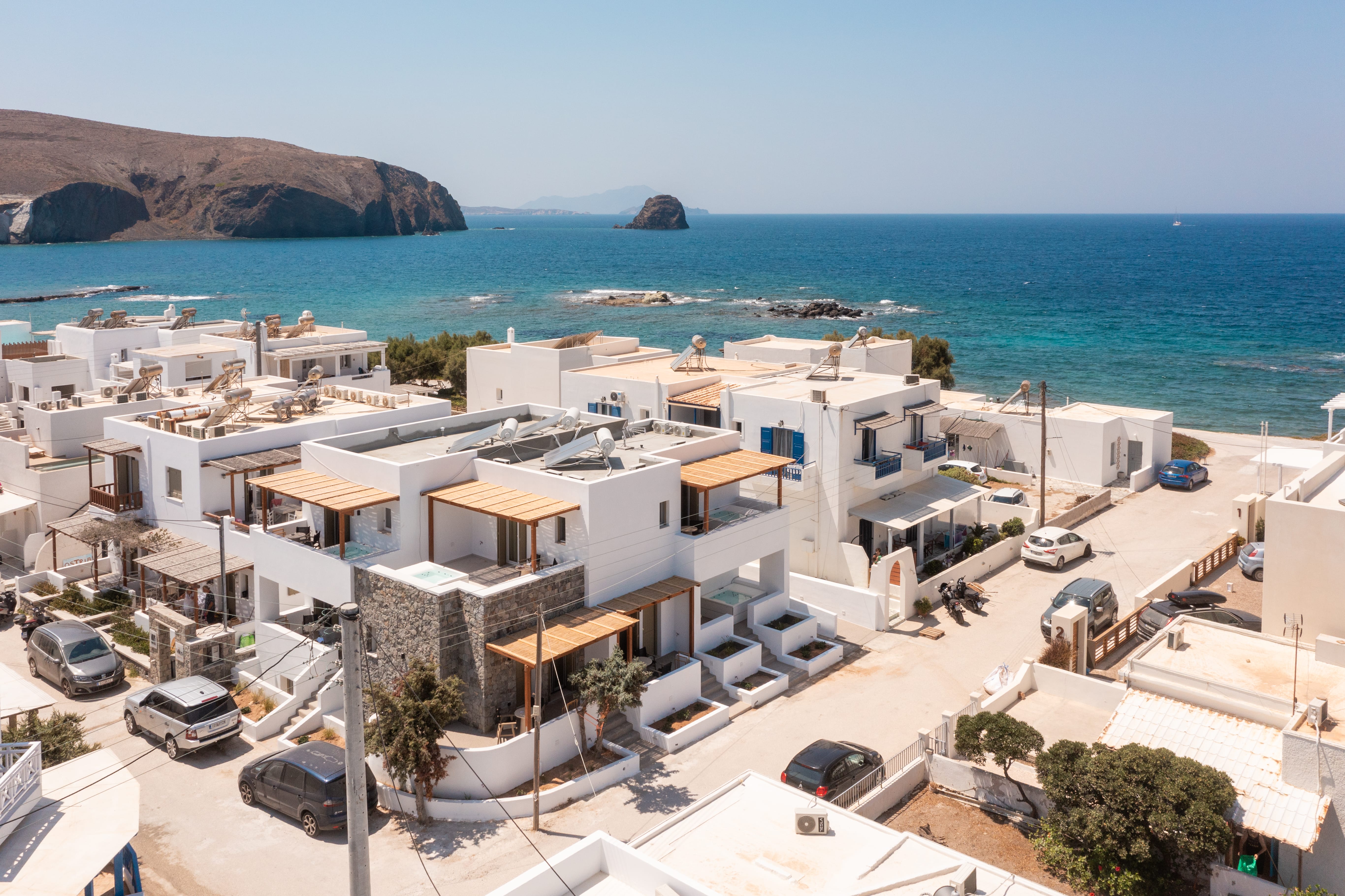 a group of white buildings next to a body of water