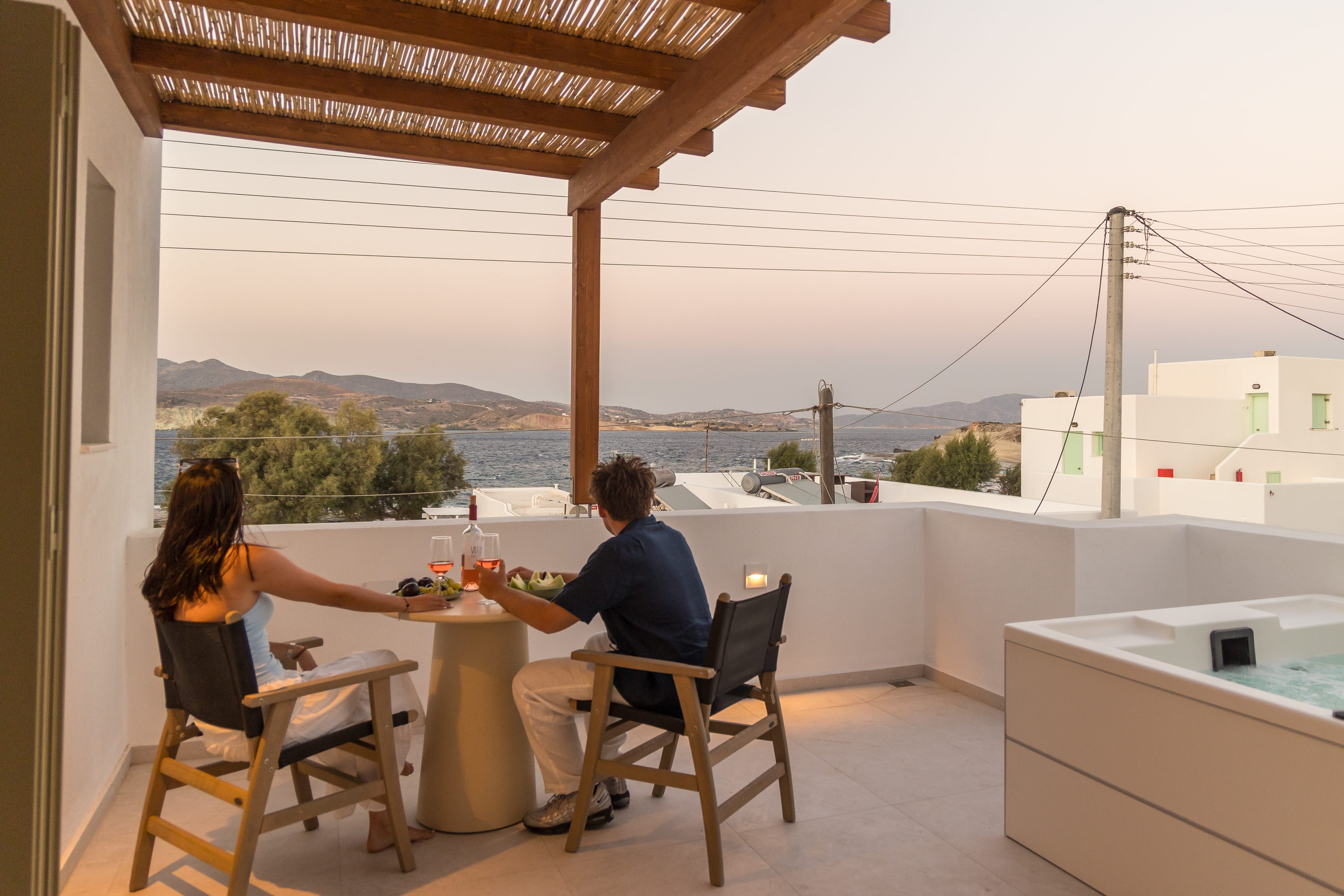 a person and person sitting at a table on a patio