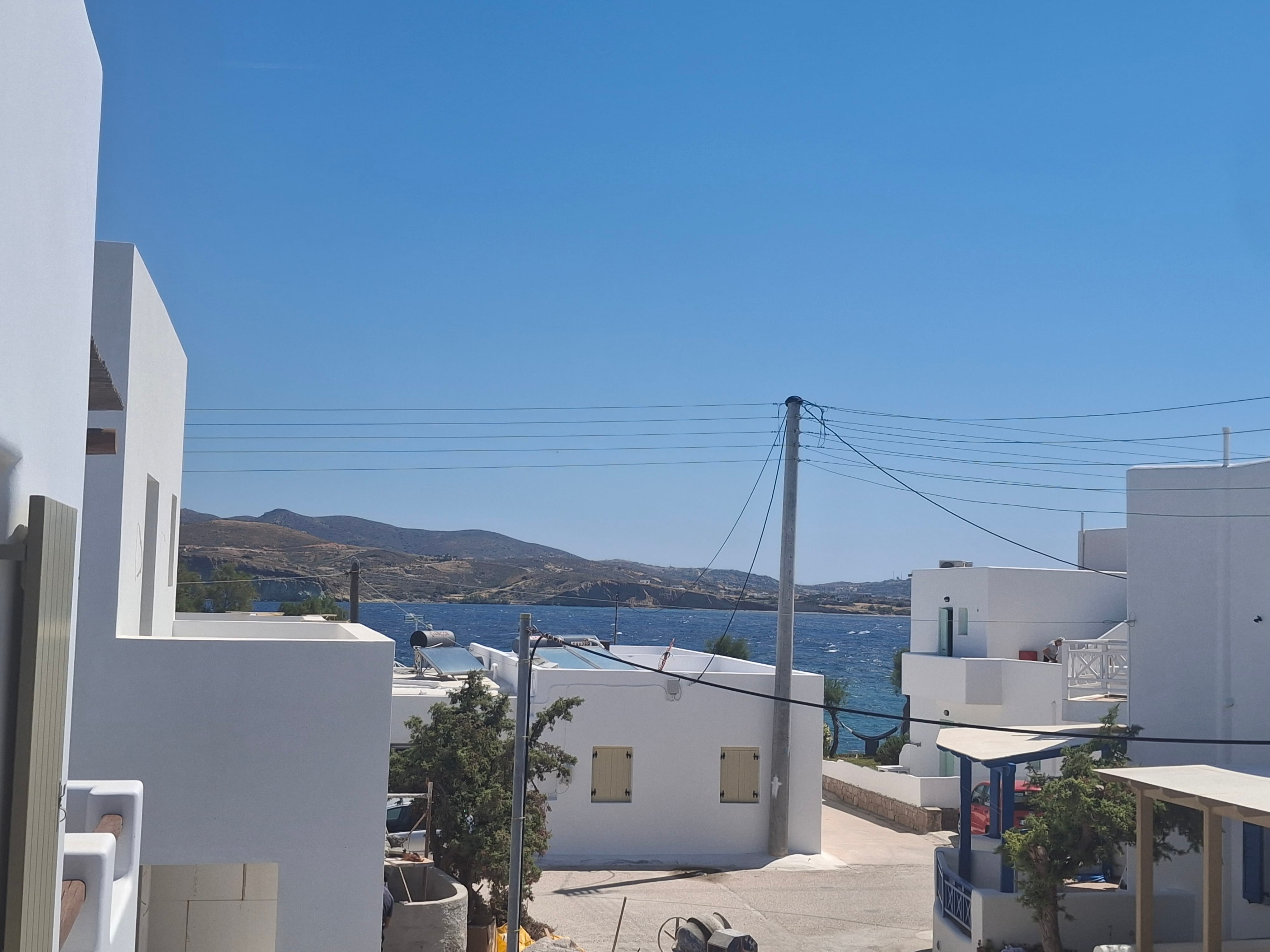 a white buildings next to a body of water