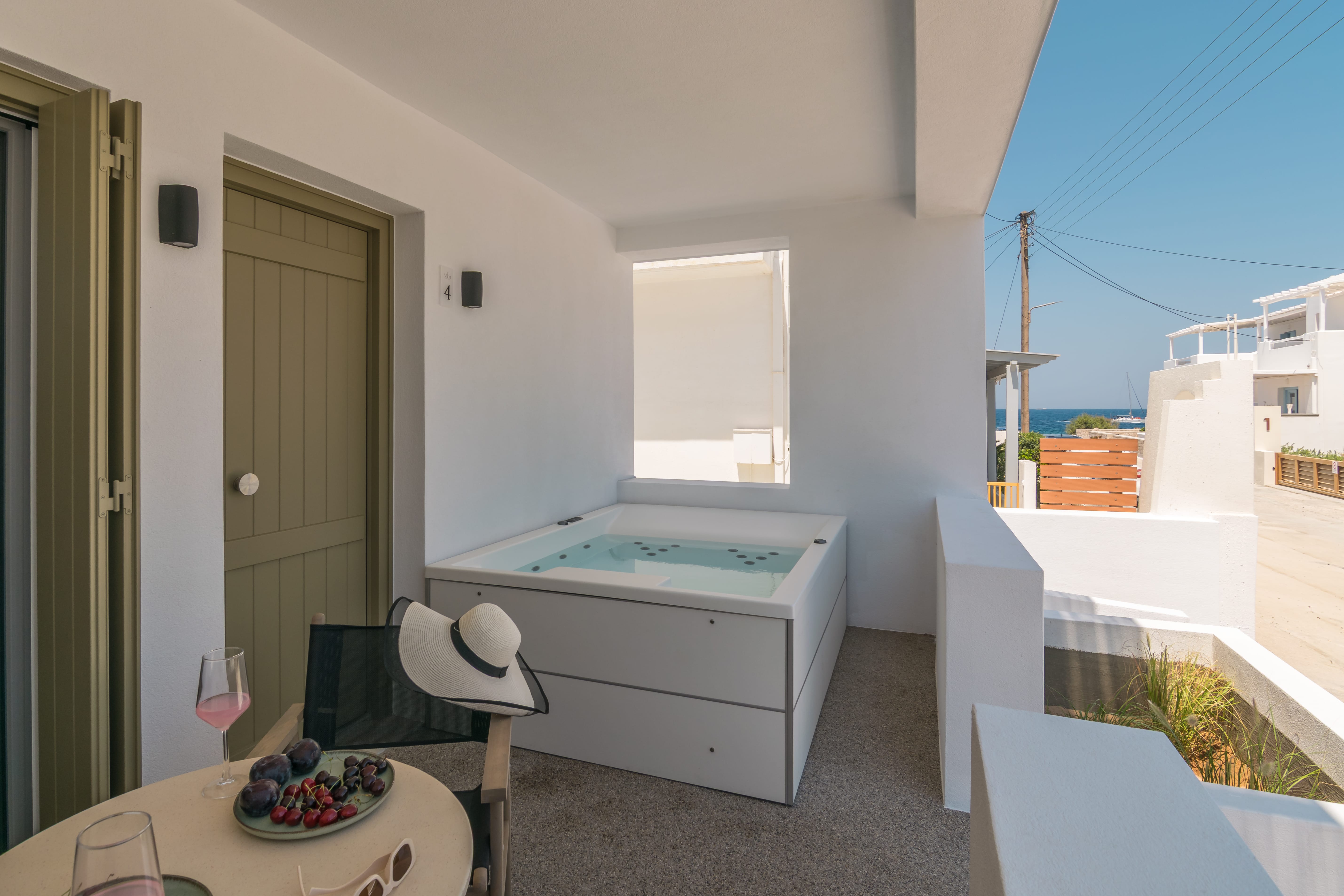 a white room with a hot tub and a table