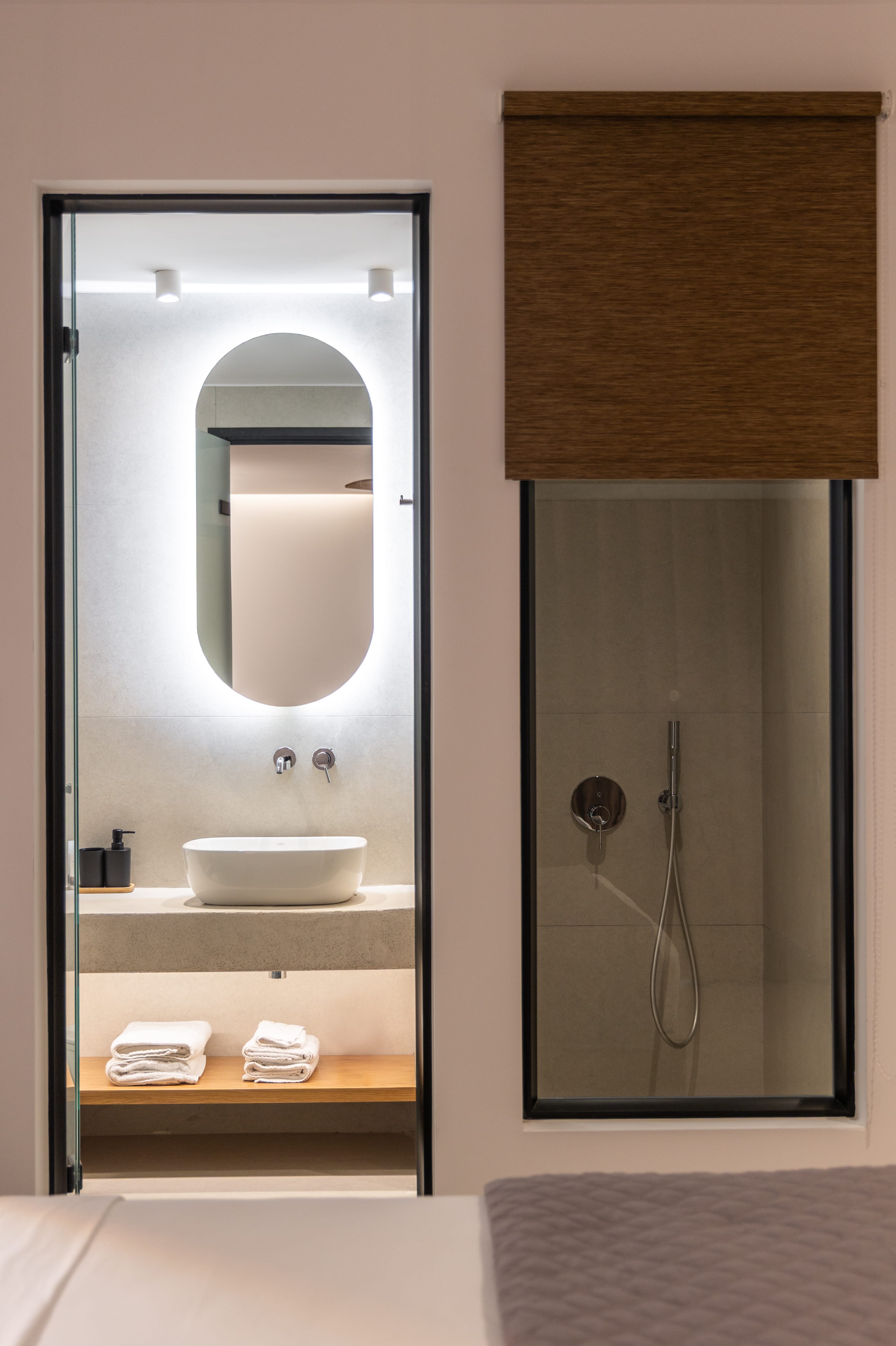 a bathroom with a mirror and a shower