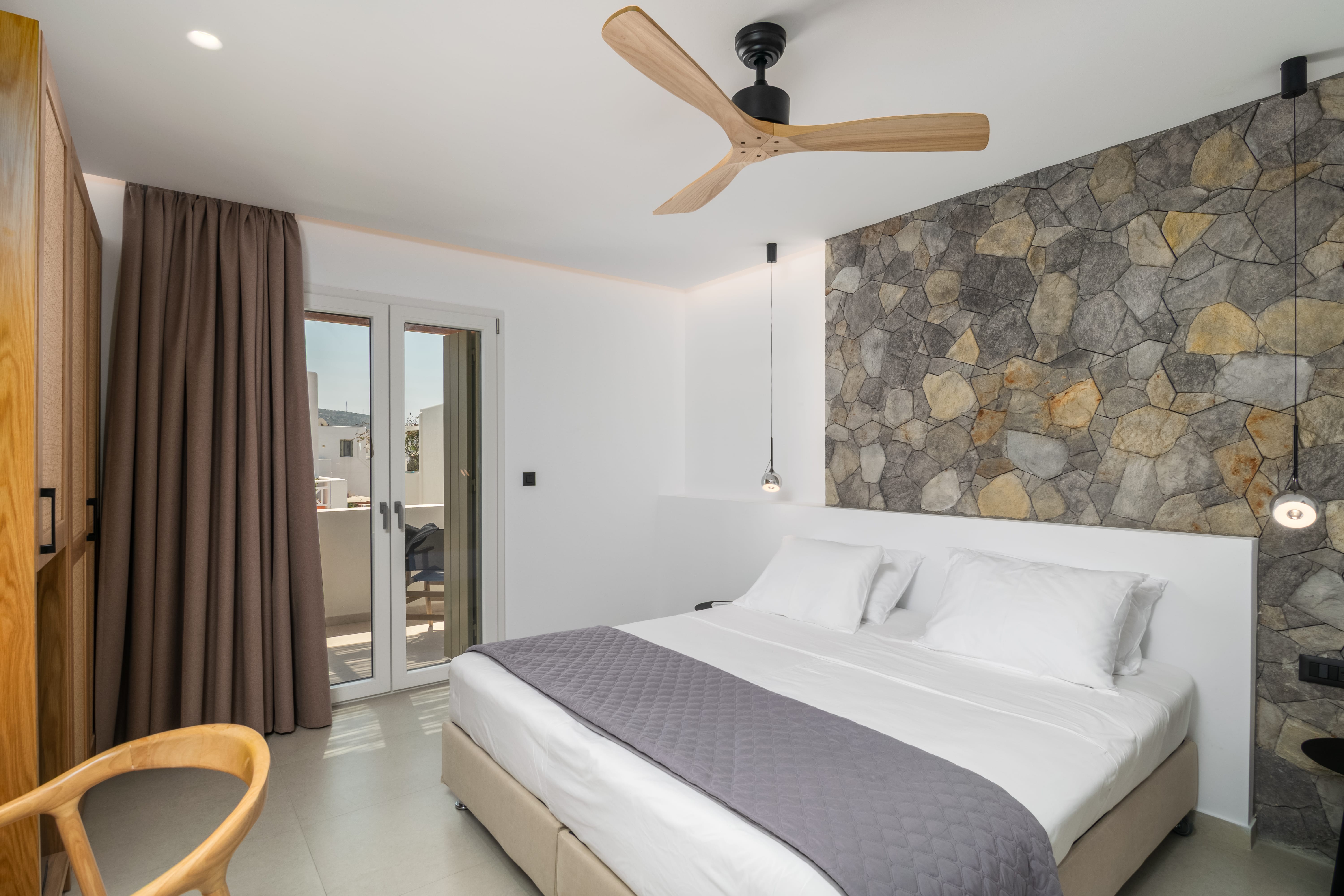 a room with a bed and a ceiling fan
