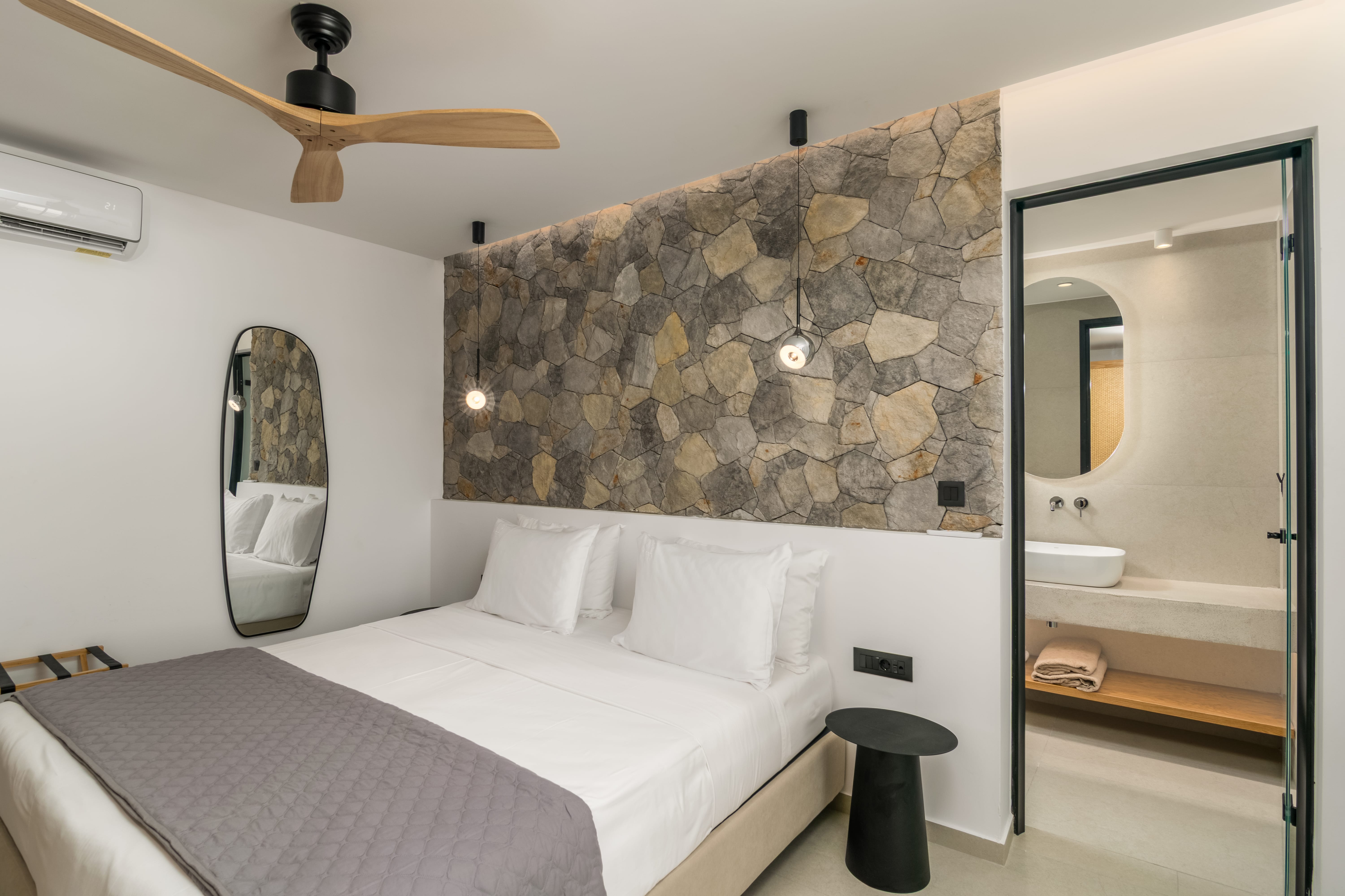 a bed with a fan and a mirror