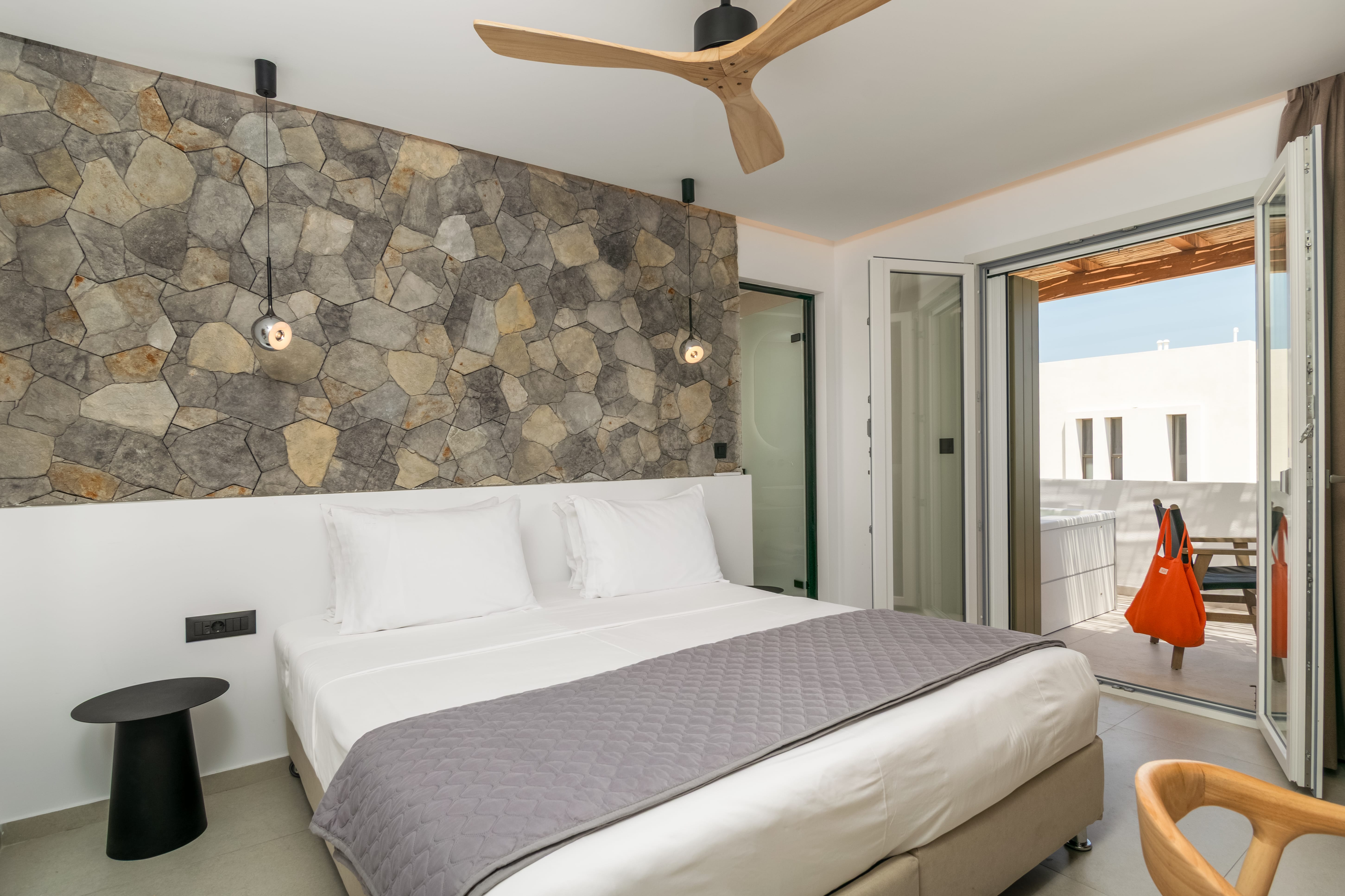 a bedroom with a bed and a ceiling fan