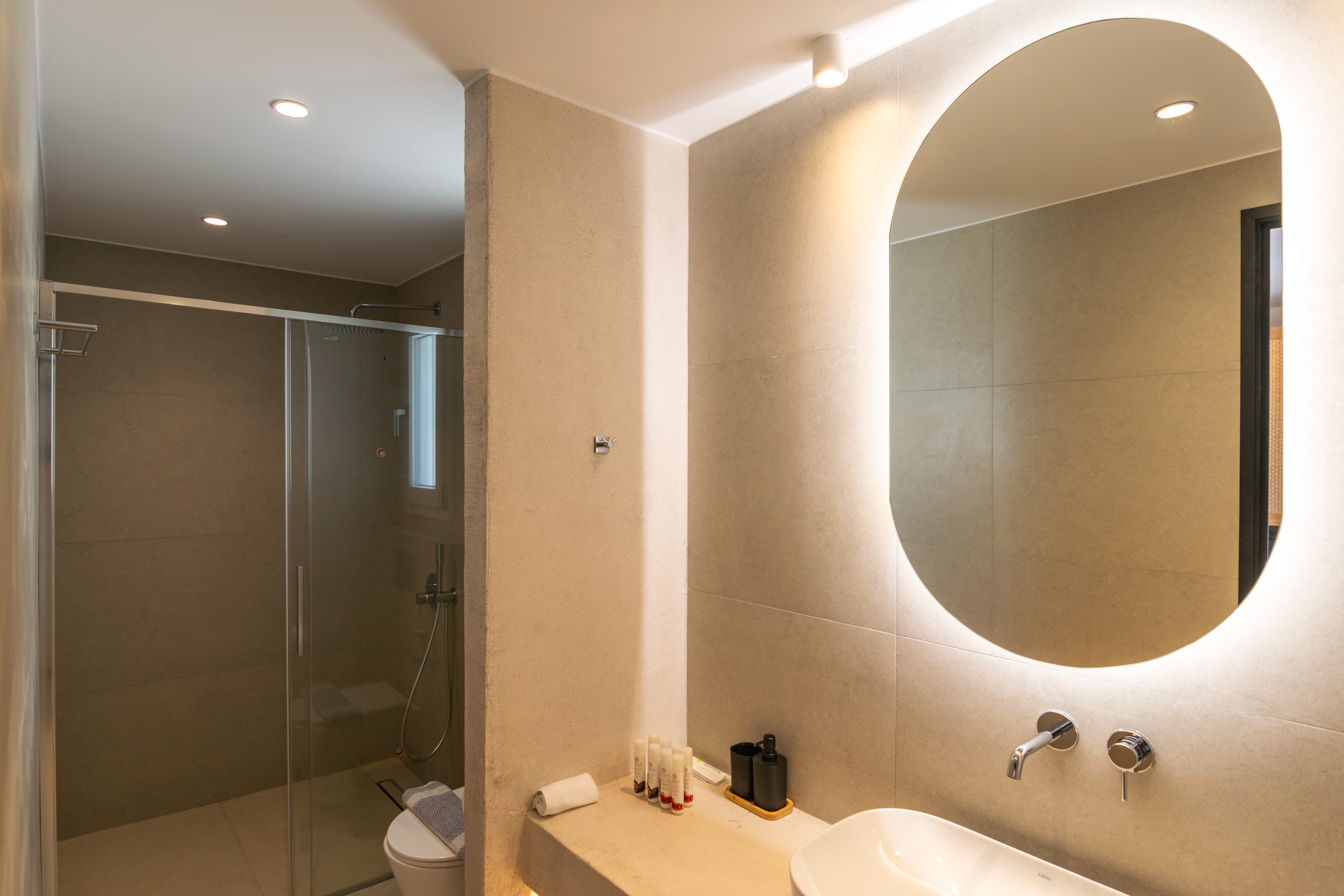 a bathroom with a mirror and shower