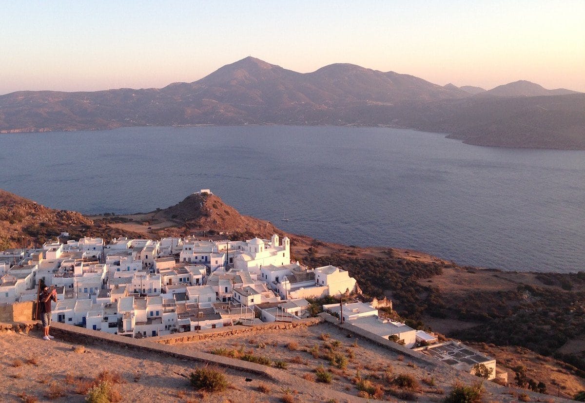 a white building next to a body of water