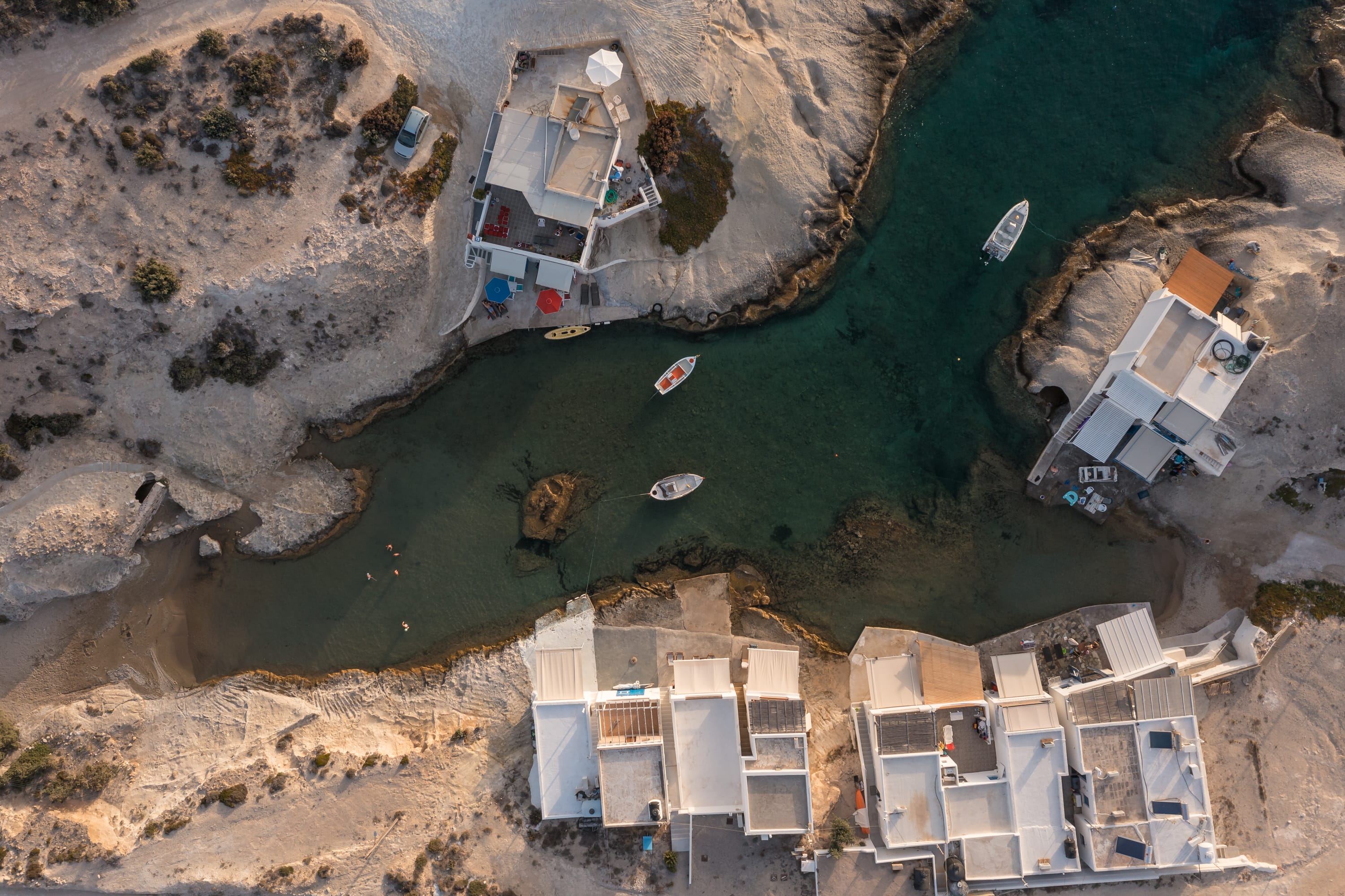 a aerial view of a river with houses and boats