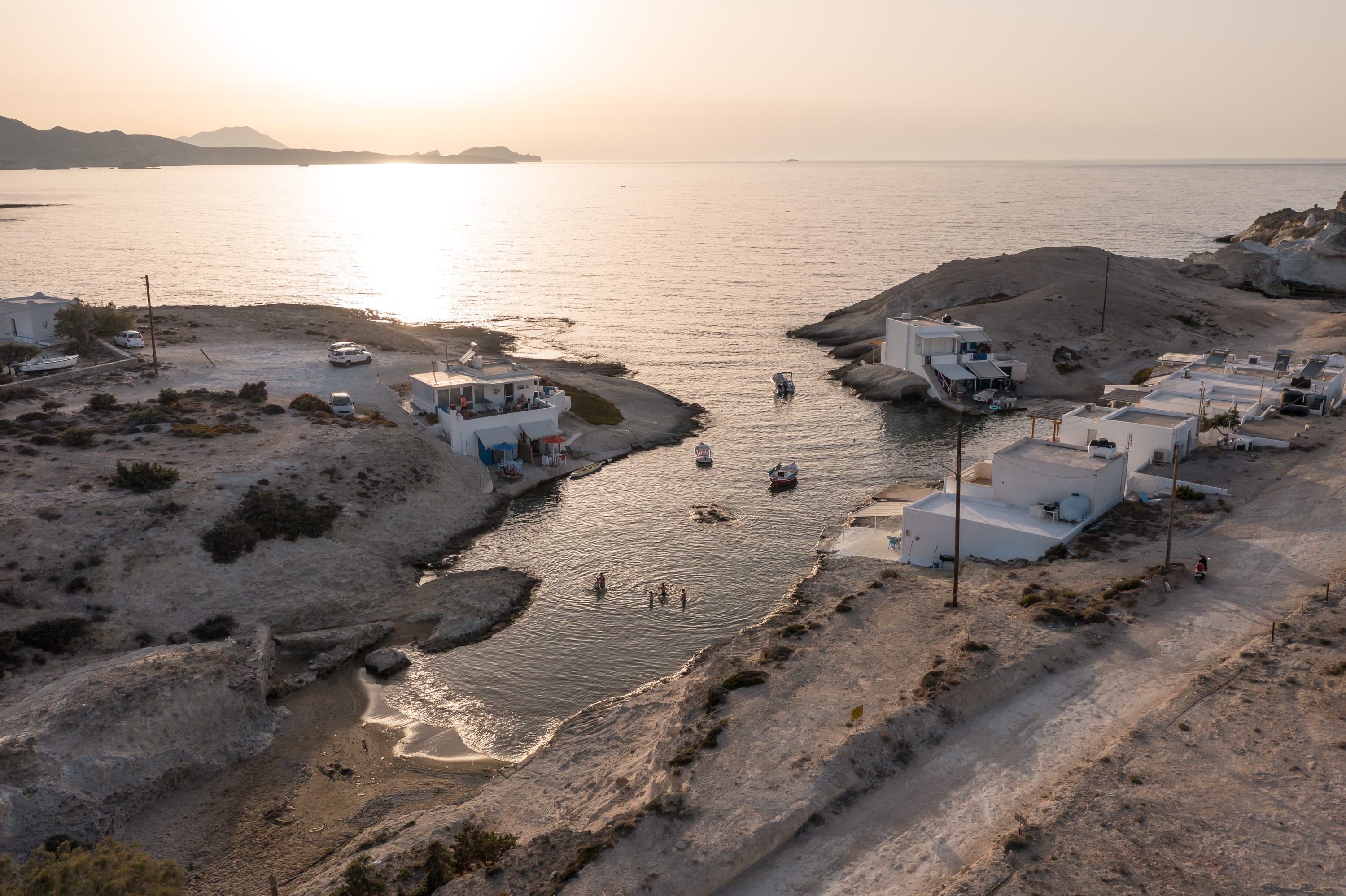 a beach with buildings and a body of water