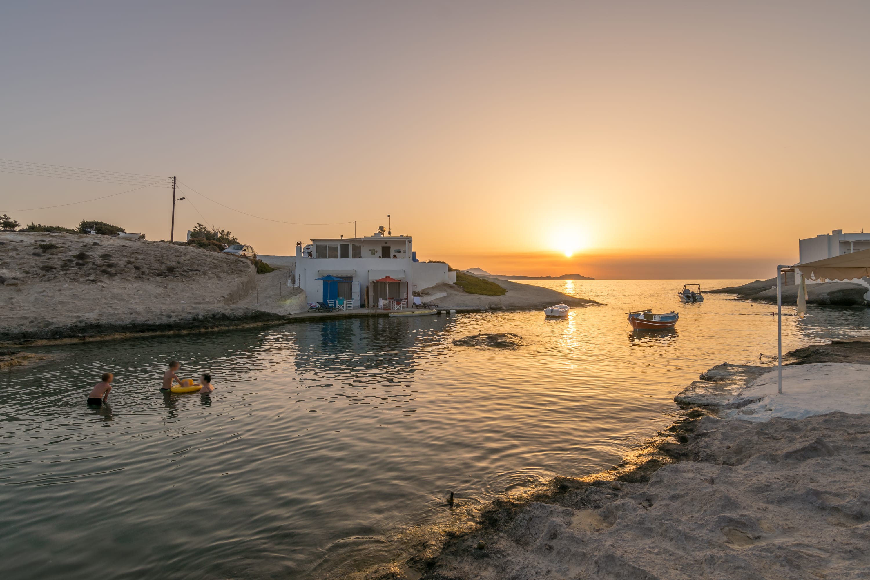 a body of water with boats and a building in the background