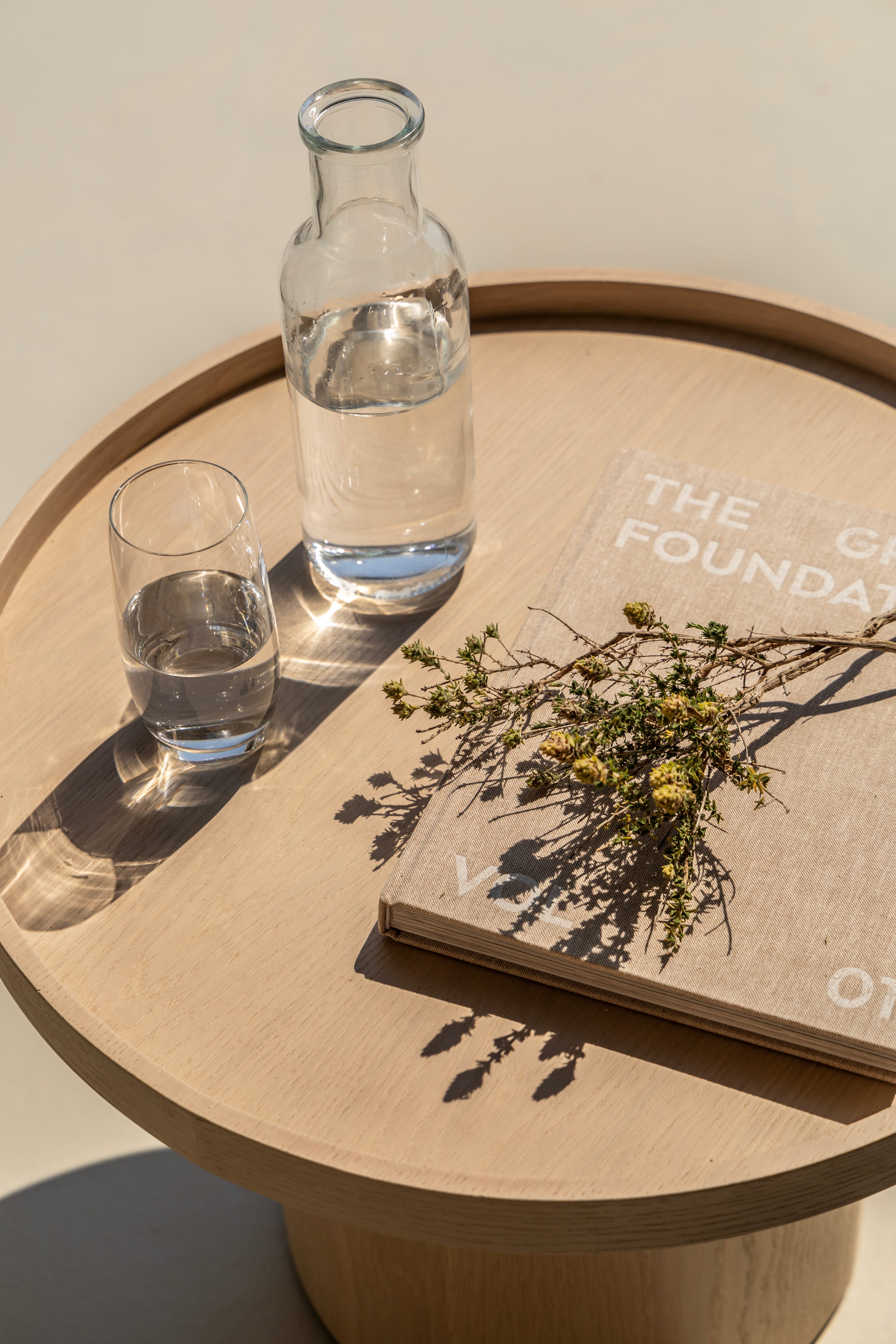 a glass bottle and a glass of water on a tray