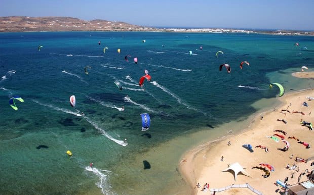 a group of people parasailing on a beach